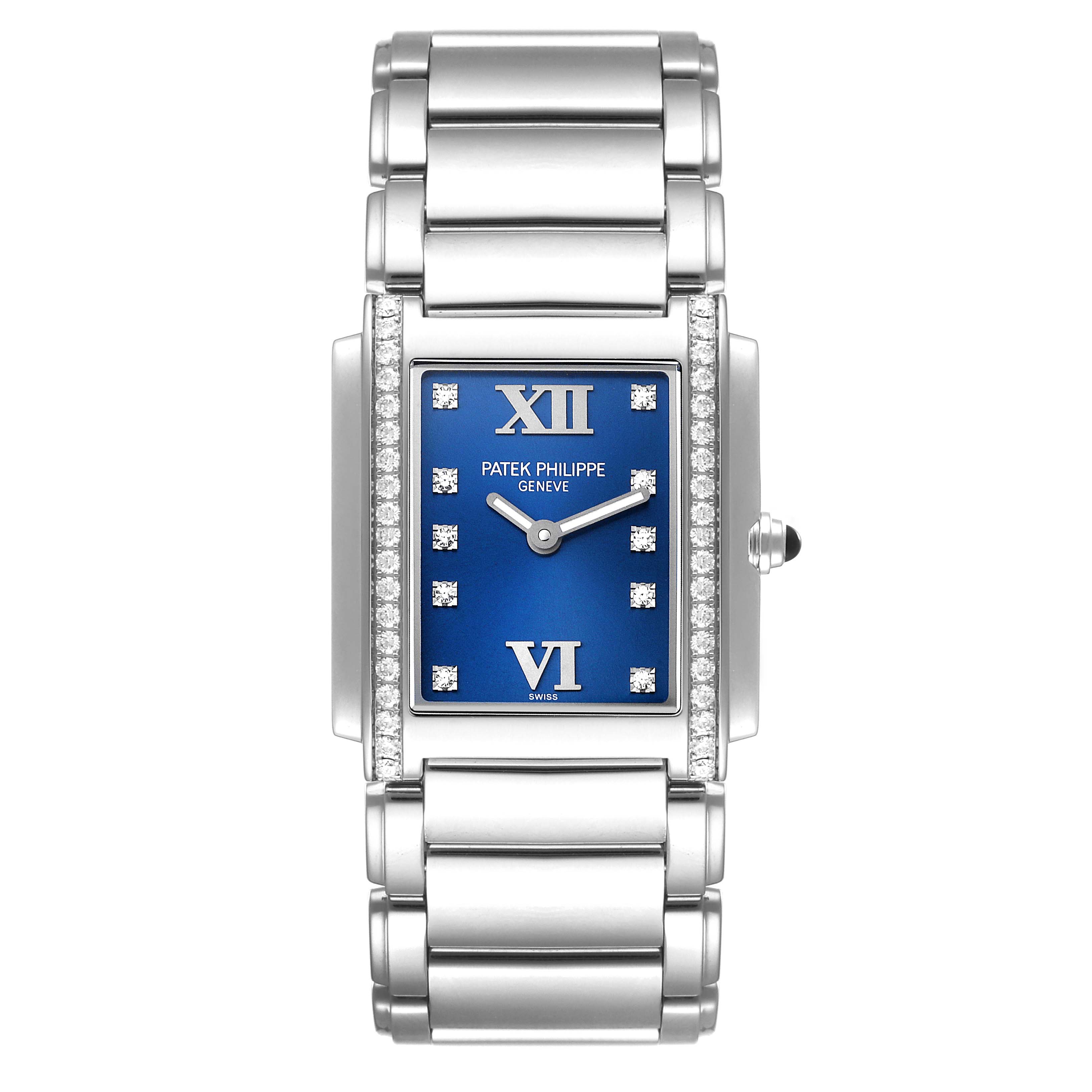 The image shows a front view of the Patek Philippe Twenty-4 4910/10A-012 Women's Stainless Steel Blue Dial 4910/10A-012 Women's Stainless Steel Blue Dial watch, highlighting its blue dial, diamond bezel, and metal bracelet.