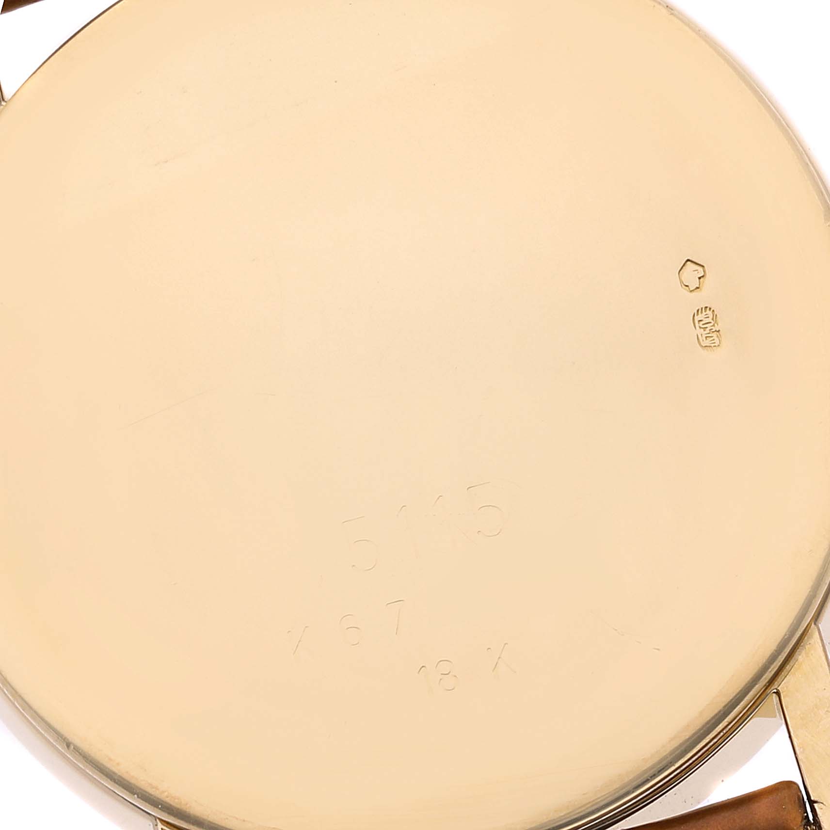 This image shows the back case of a Rolex Cellini 5115 Men's Yellow Gold Silver Dial 5115 Men's Yellow Gold Silver Dial watch, focusing on the engravings and gold markings.