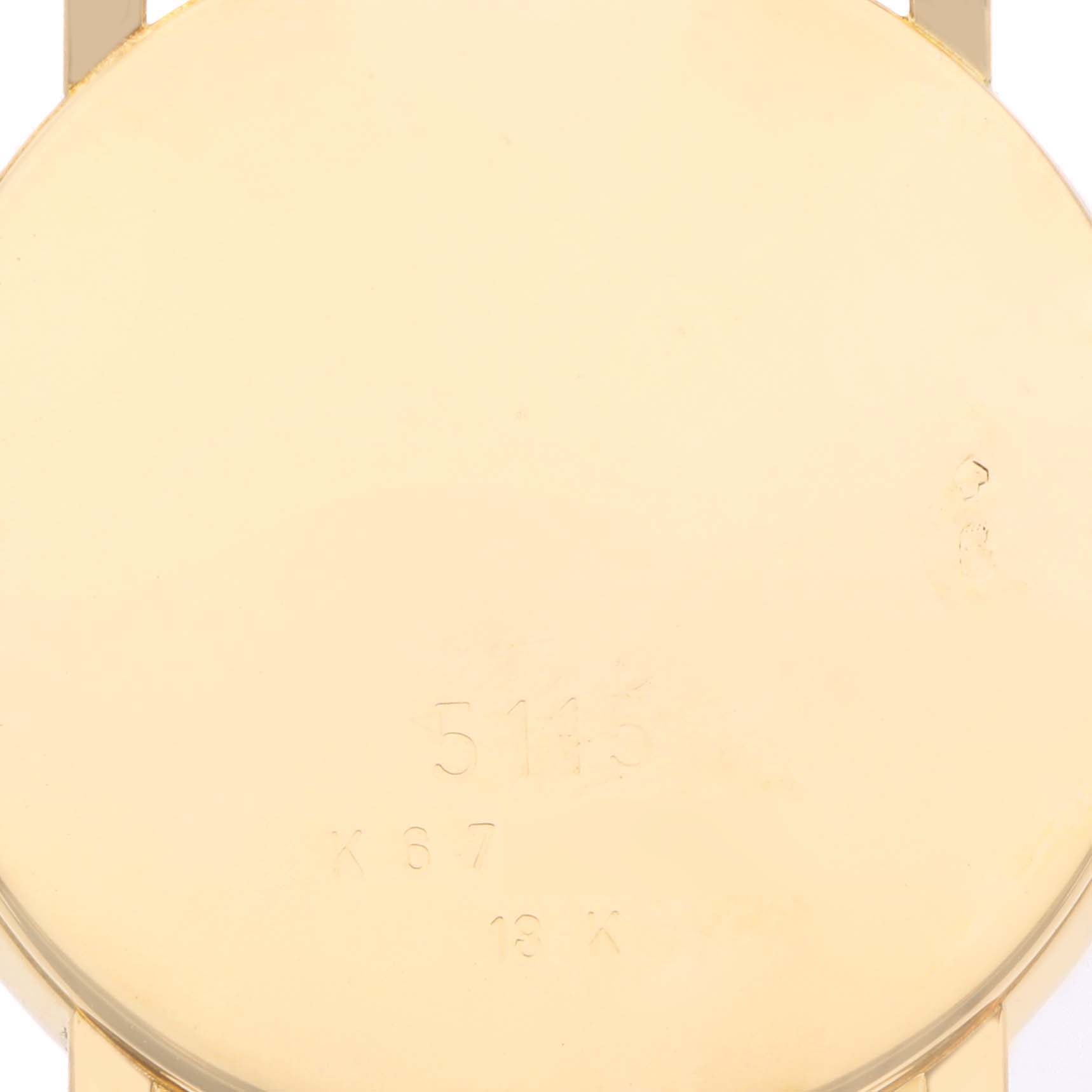 The image shows the back of a Rolex Date 5115 Men's Yellow Gold Silver Dial 5115 Men's Yellow Gold Silver Dial watch case, featuring engraved markings.