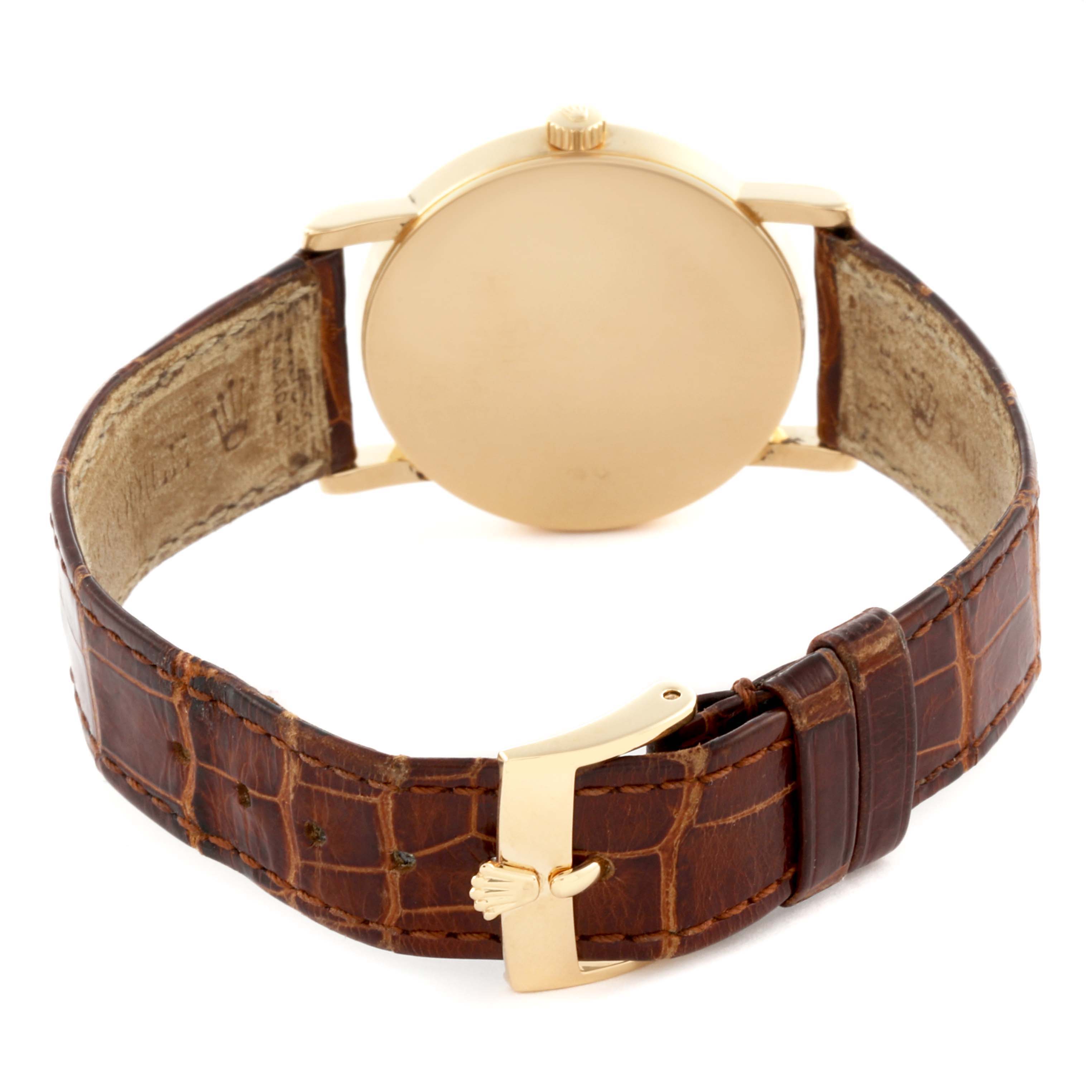 The Rolex Date 5115 Men's Yellow Gold Silver Dial 5115 Men's Yellow Gold Silver Dial model is shown from the back, highlighting the case back, crown, and brown leather strap with a gold clasp.