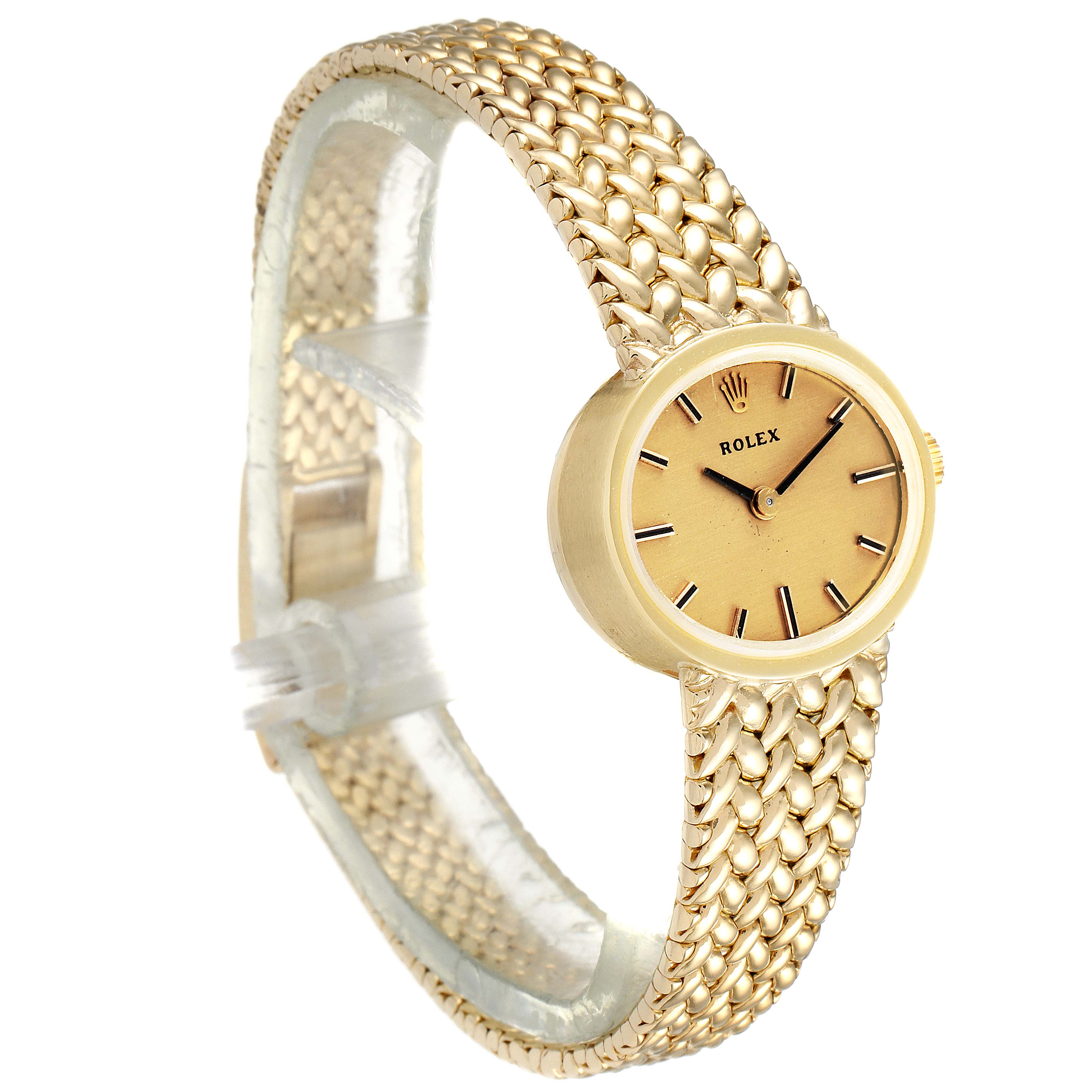 The image shows a Rolex Cocktail  Women
s Yellow Gold Champagne Dial  Women
s Yellow Gold Champagne Dial model watch angled to display its gold bracelet and round face.