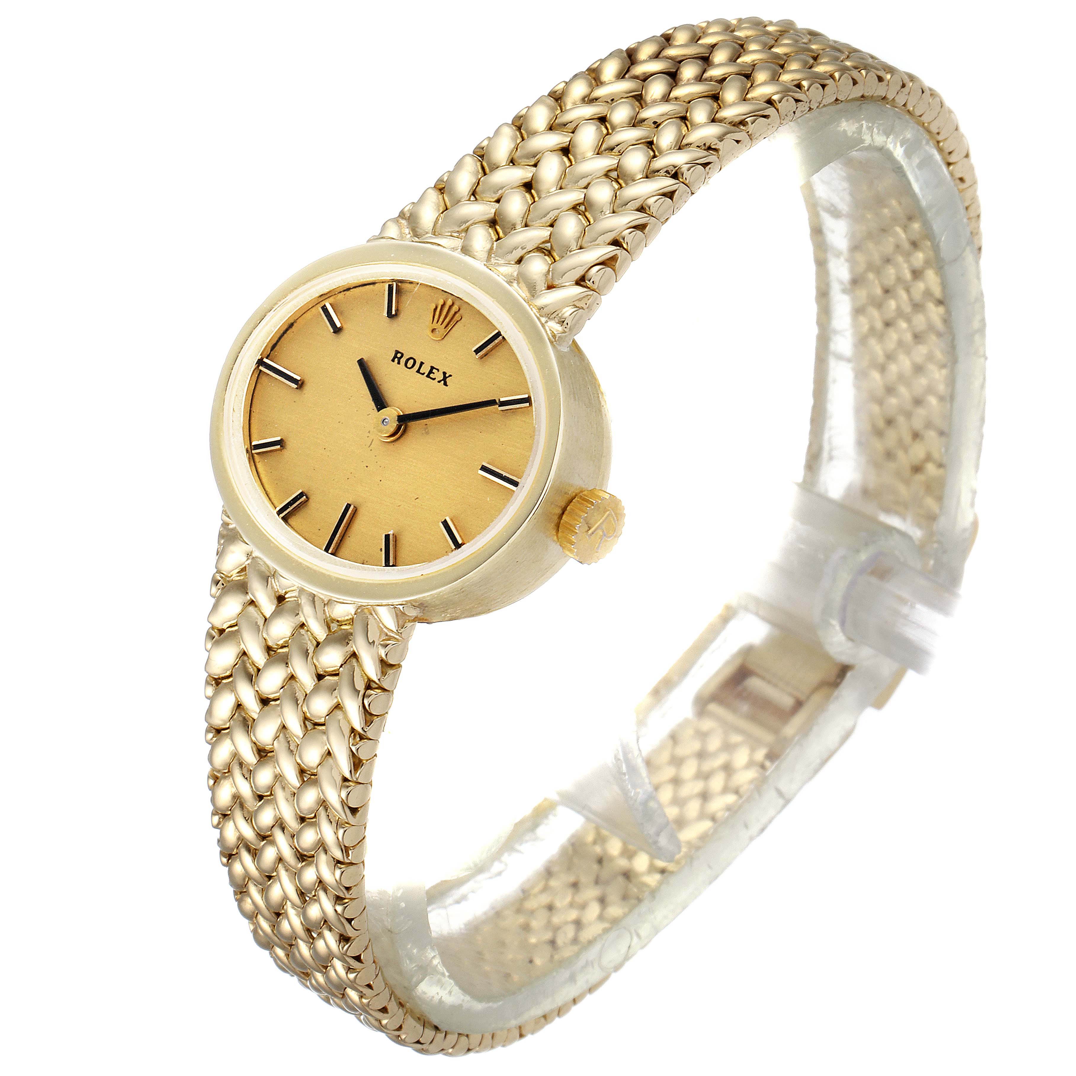 The image shows a front angled view of a gold Rolex Cocktail  Women
s Yellow Gold Champagne Dial  Women
s Yellow Gold Champagne Dial model watch, highlighting the dial, bezel, and woven bracelet.