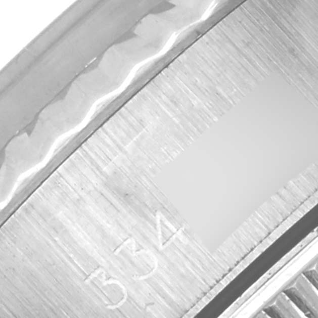 The image shows a close-up of the side of a Rolex Date 6917 Women's Stainless Steel Silver Dial 6917 Women's Stainless Steel Silver Dial watch with part of the case and the engraved serial number visible.