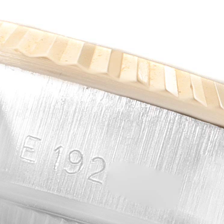 The image shows a close-up of the rehaut and fluted bezel of a Rolex Datejust 69173 Women's Steel and Gold (two tone) Black Dial 69173 Women's Steel and Gold (two tone) Black Dial watch, with part of an inscription visible.