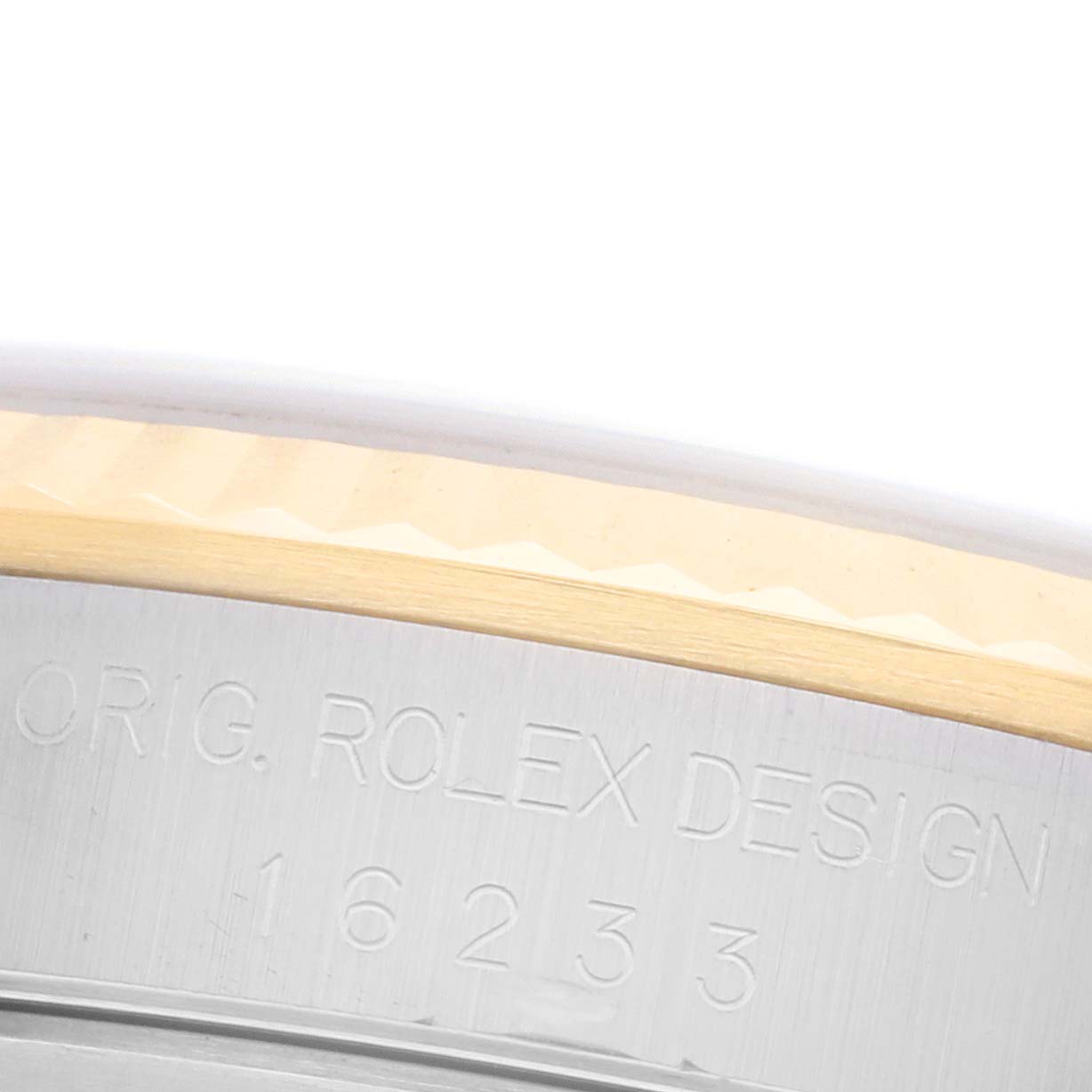 The image shows a close-up of the side of a Rolex Datejust 16233 Men's Steel and Gold (two tone) White Dial 16233 Men's Steel and Gold (two tone) White Dial, highlighting the engraved model number and design details.