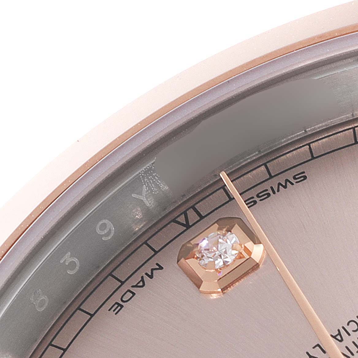 The close-up image shows the upper-left section of the Rolex Datejust 41 126301 Men's Steel and Gold (two tone) Pink Dial 126301 Men's Steel and Gold (two tone) Pink Dial's dial, featuring a diamond-set hour marker and Rolex branding.