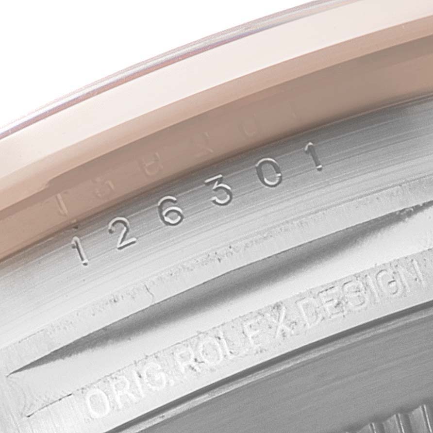 This image shows a close-up view of the engraved serial number and "Orig. Rolex Design" inscription on the case back of a Rolex Datejust 41 126301 Men's Steel and Gold (two tone) Pink Dial 126301 Men's Steel and Gold (two tone) Pink Dial.
