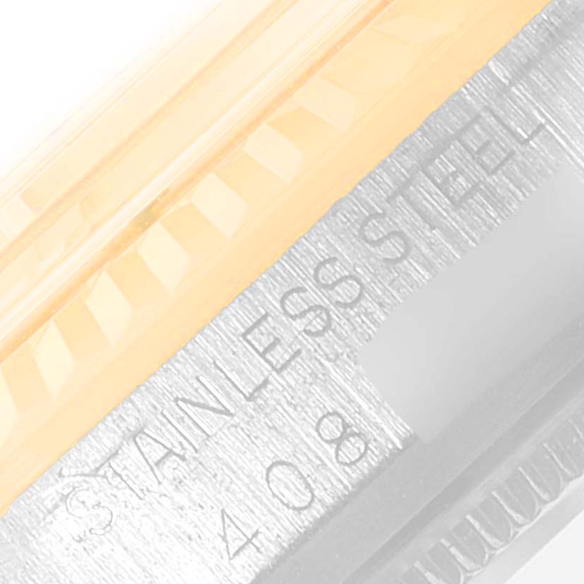 The image shows a close-up of the outer edge of the bezel and case of the Rolex Vintage Collection 1601 Men's Steel and Gold (two tone) Champagne Dial 1601 Men's Steel and Gold (two tone) Champagne Dial model watch, highlighting the "STAINLESS STEEL" inscription.