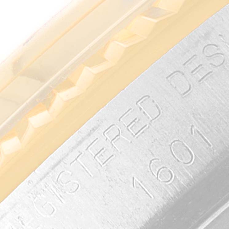 This close-up image shows the side bezel and engraved details of a Vintage Collection Rolex model 1601.