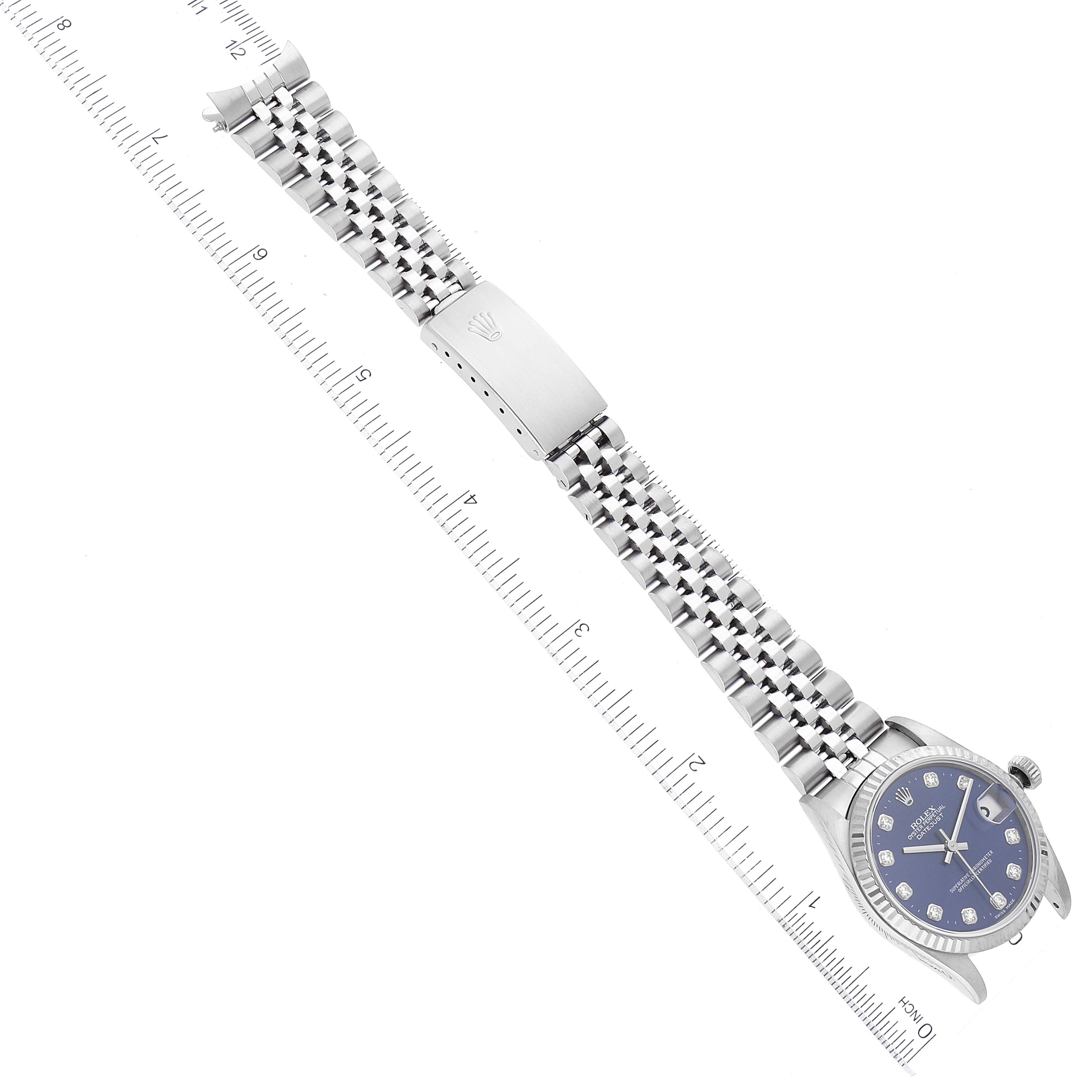 This image shows a top-view angle of a Rolex Mid-Size 68274 Women's Stainless Steel Blue Dial 68274 Women's Stainless Steel Blue Dial watch, displaying its face, bezel, bracelet, and clasp, with a ruler for scale.