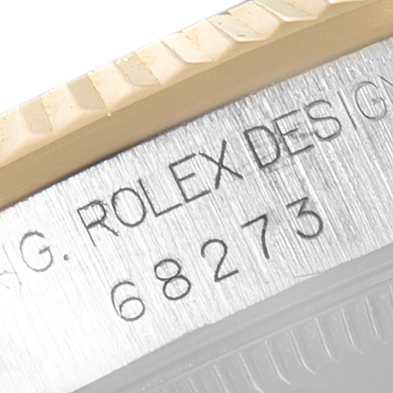This close-up image shows the side view of a Mid-Size Rolex watch model 68273, highlighting the edge of the bezel and engravings.