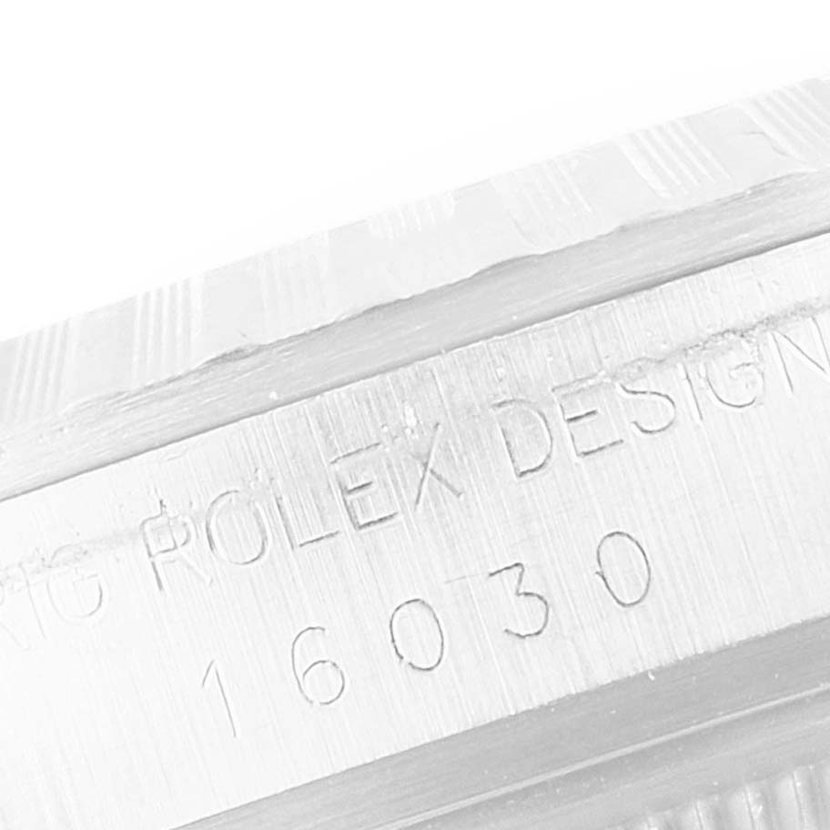 The image shows a close-up of the case side with engraved text on the Rolex Vintage Collection 16030 Men's Stainless Steel Silver Dial 16030 Men's Stainless Steel Silver Dial model.