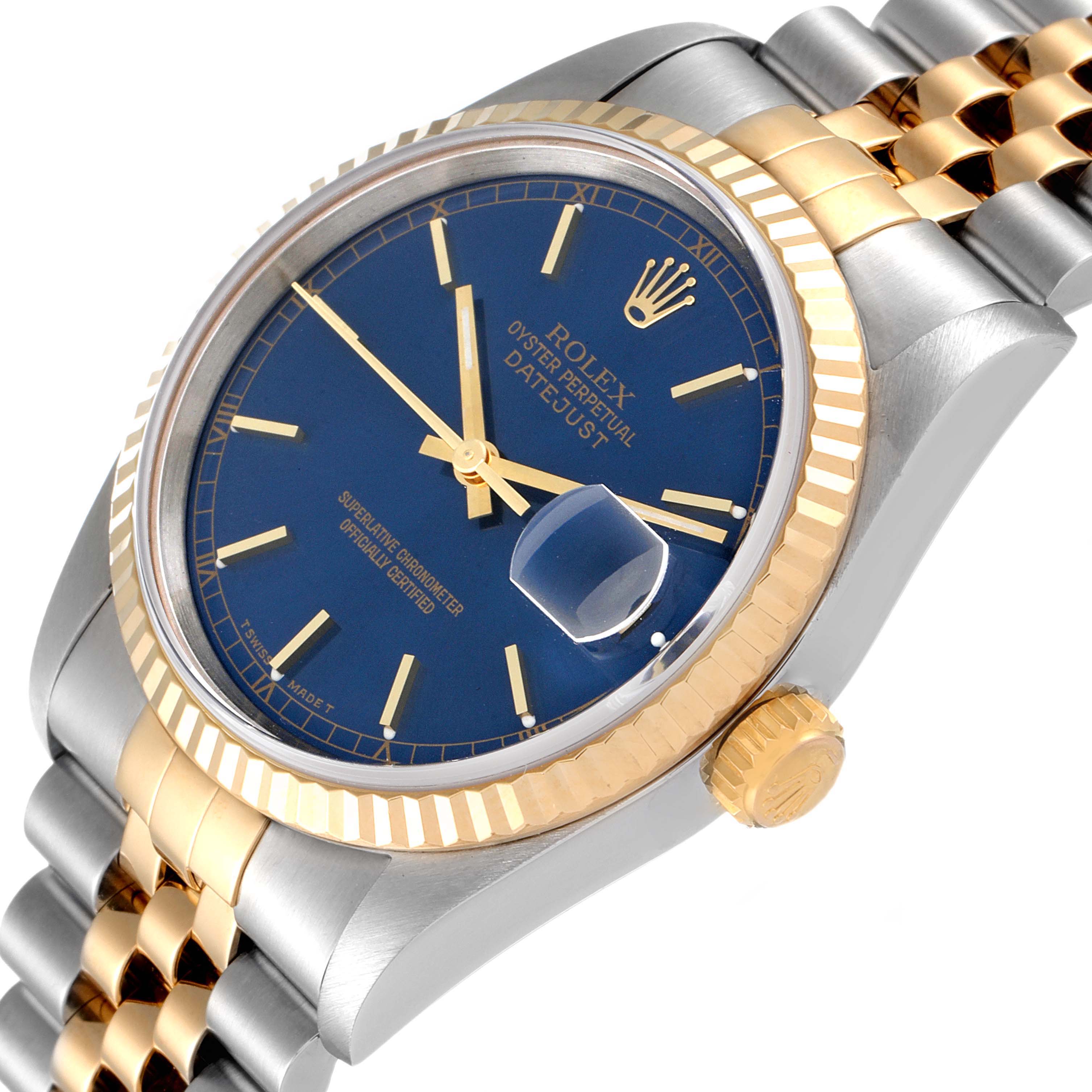 The image shows a Rolex Datejust 16233 Men's Steel and Gold (two tone) Blue Dial 16233 Men's Steel and Gold (two tone) Blue Dial watch from an angle highlighting the face, bezel, crown, and a portion of the bracelet.