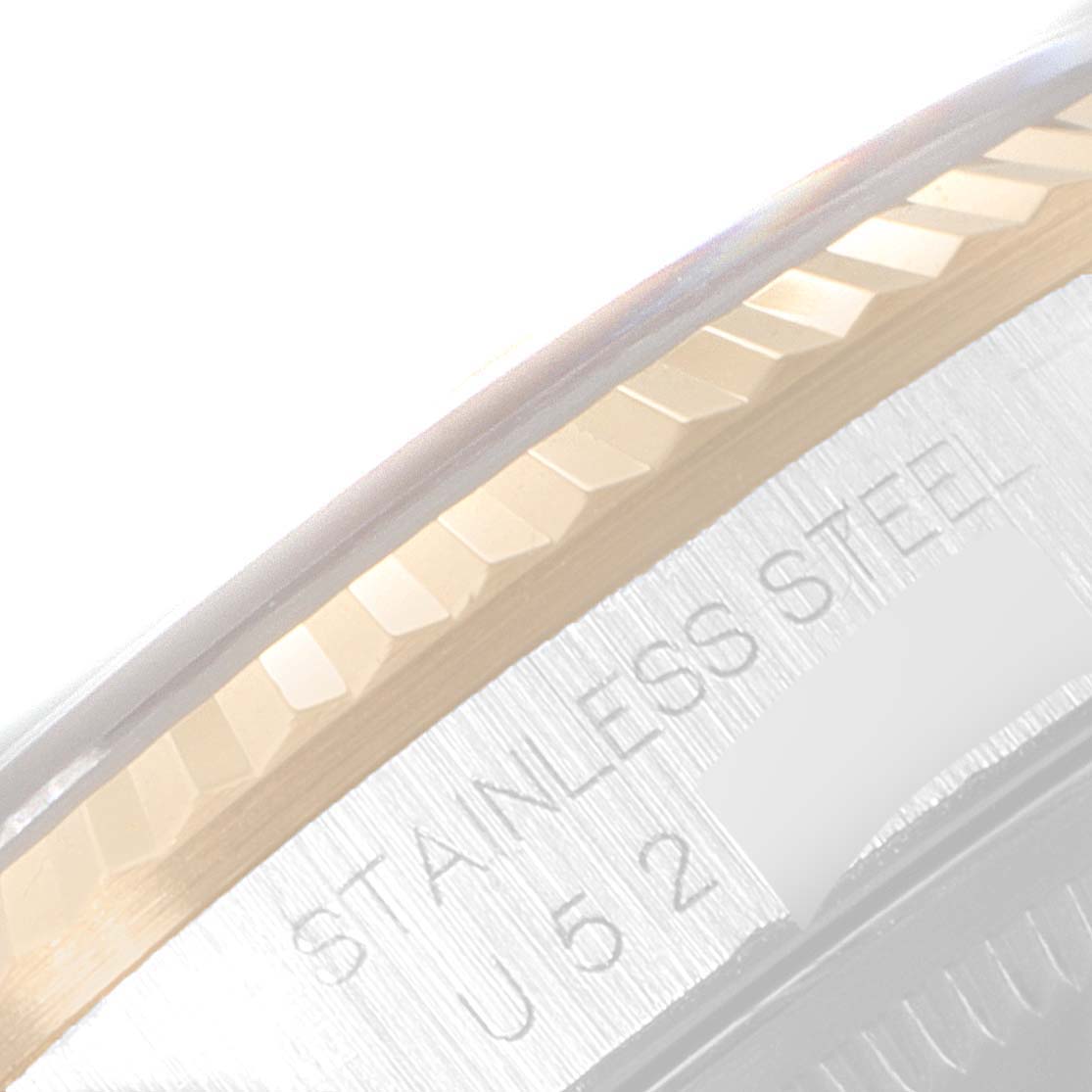 The image shows a close-up angle of the bezel and part of the case with engraved text of the Rolex Datejust 16233 Men's Steel and Gold (two tone) Blue Dial 16233 Men's Steel and Gold (two tone) Blue Dial model.