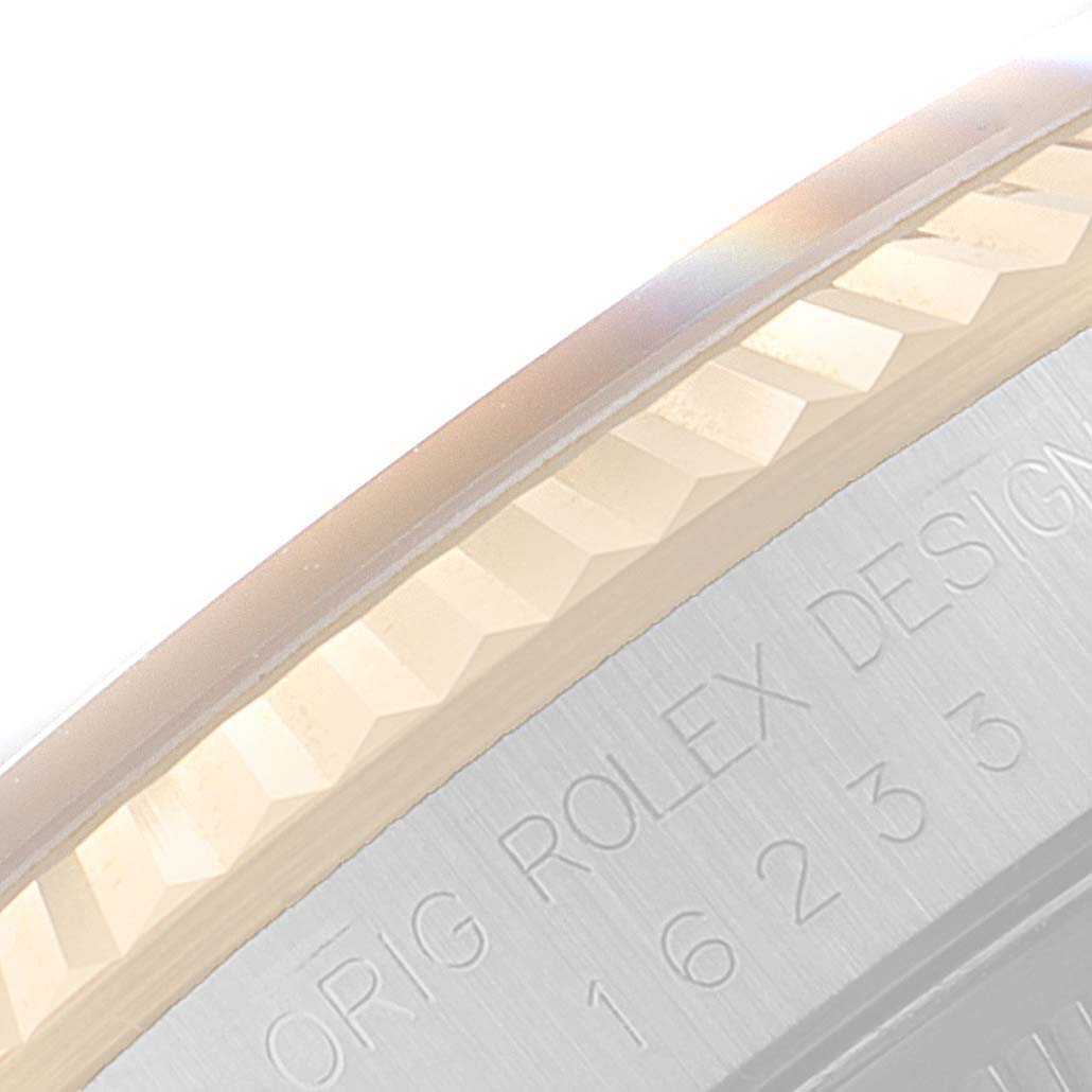 The image shows a close-up view of the fluted bezel and case back of a Rolex Datejust 16233 Men's Steel and Gold (two tone) Blue Dial 16233 Men's Steel and Gold (two tone) Blue Dial watch.