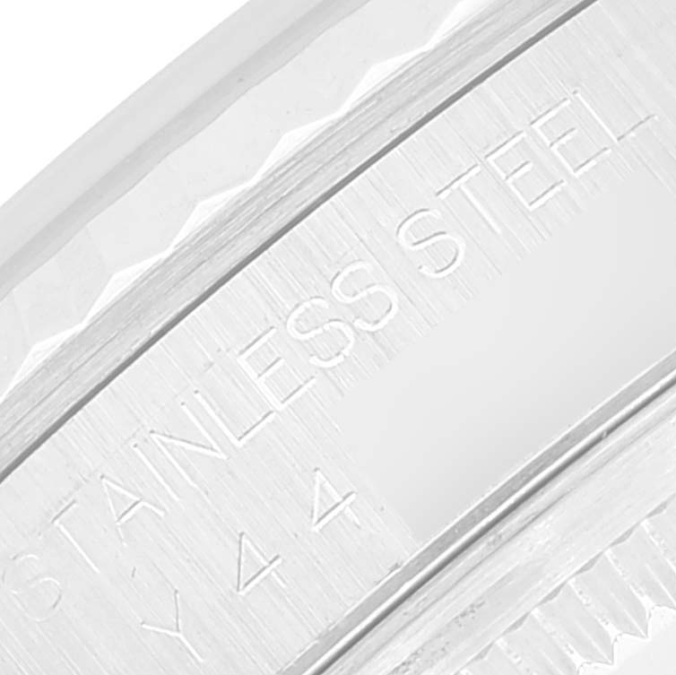 The image shows a close-up of the stainless steel casing and part of the fluted bezel of a Rolex Datejust 16234 Men's Stainless Steel Mother of Pearl Dial 16234 Men's Stainless Steel Mother of Pearl Dial watch.