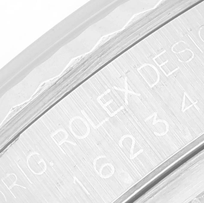 This close-up image shows the engraved bezel and serial number area of a Rolex Datejust 16234 Men's Stainless Steel Mother of Pearl Dial 16234 Men's Stainless Steel Mother of Pearl Dial watch.