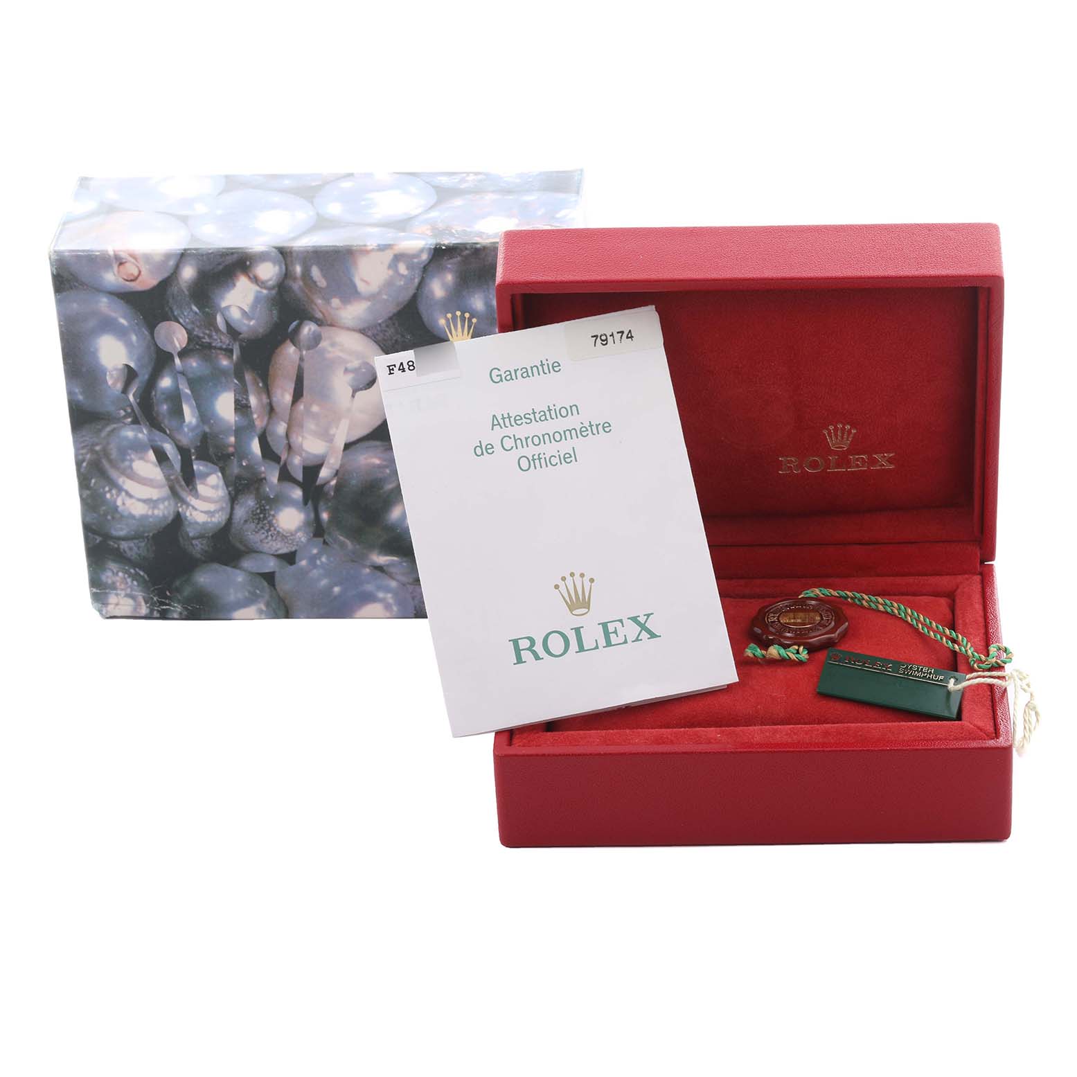 The image shows a Rolex Datejust 79174 Women's Stainless Steel Pink Dial 79174 Women's Stainless Steel Pink Dial box, warranty papers, and accessories, including tags, from a front angle.
