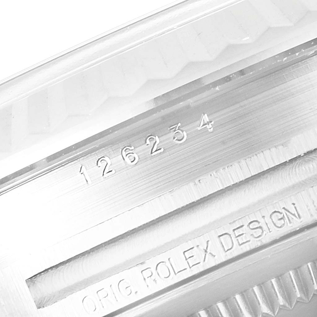 The image shows a close-up of the case's reference number and the "Orig Rolex Design" engraving on a Rolex Datejust 126234 Men's Stainless Steel Silver Dial 126234 Men's Stainless Steel Silver Dial watch.