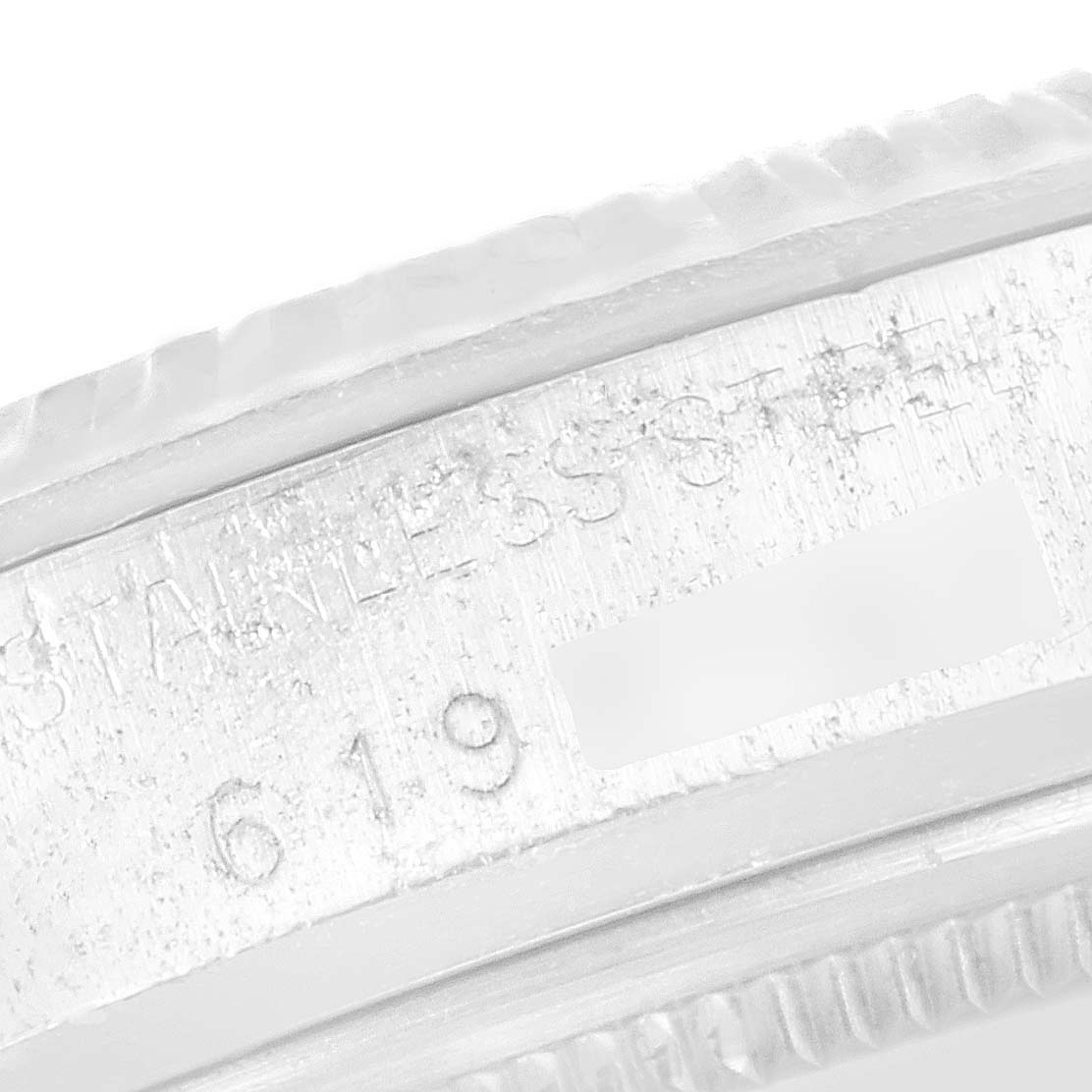 This image shows a close-up view of the outer edge and markings of the bezel on a Vintage Collection Rolex watch.