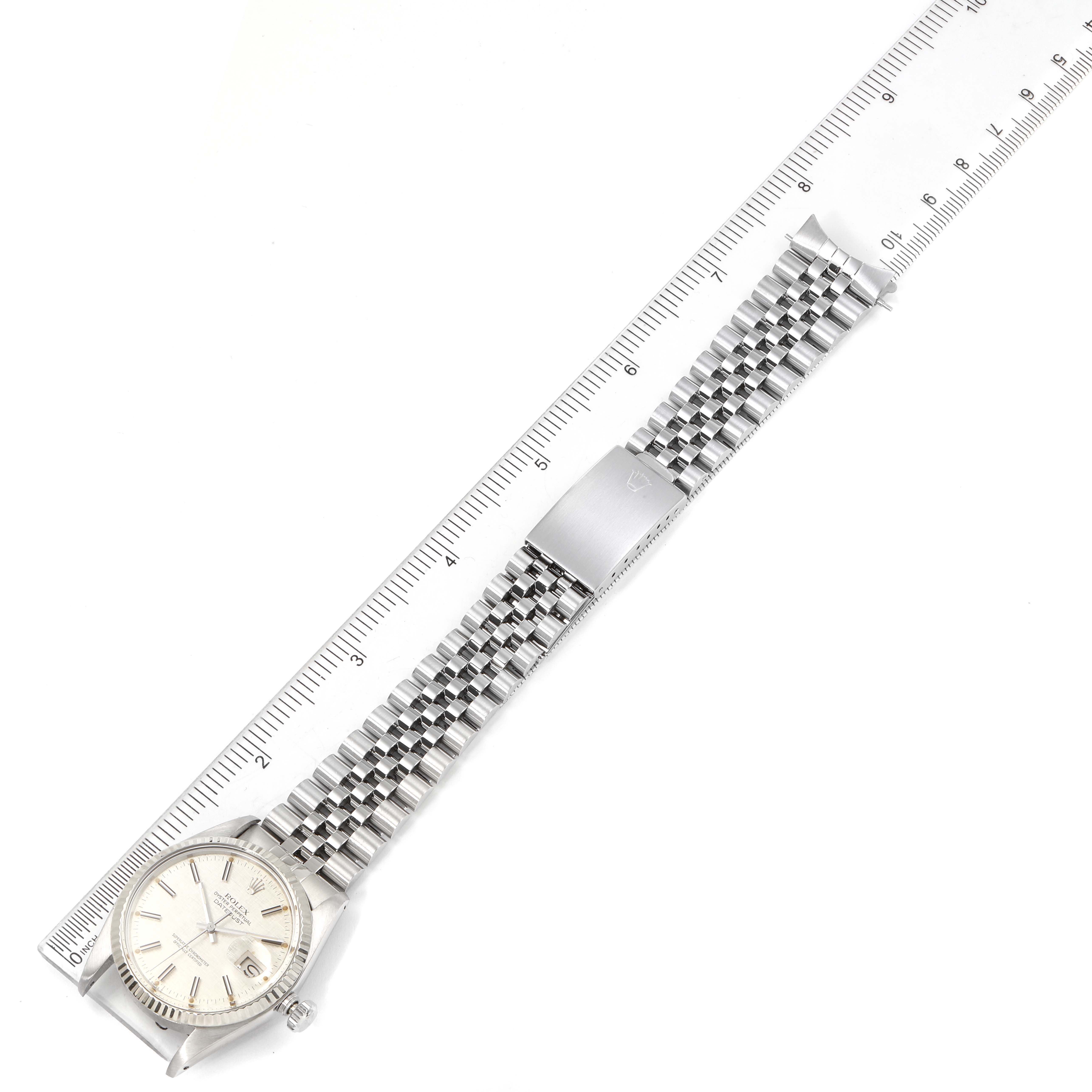 This image shows a Rolex Vintage Collection 16014 Men's Stainless Steel Silver Dial 16014 Men's Stainless Steel Silver Dial watch placed next to a ruler, displaying the watch face and metal bracelet from a top-down angle.
