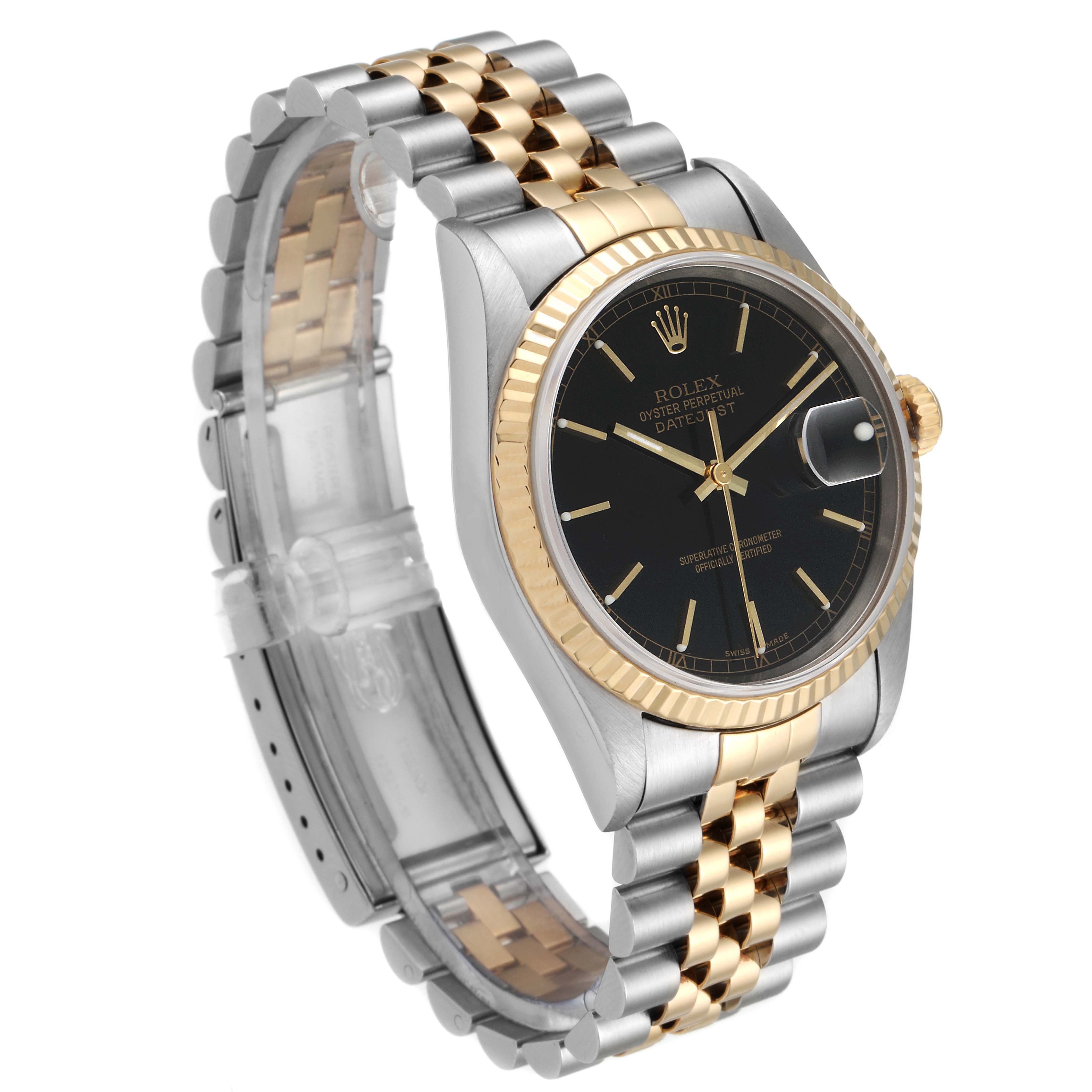 This image shows a side angle of a Rolex Datejust 16233 Men's Steel and Gold (two tone) Black Dial 16233 Men's Steel and Gold (two tone) Black Dial watch highlighting its two-tone bracelet, black dial, and fluted bezel.