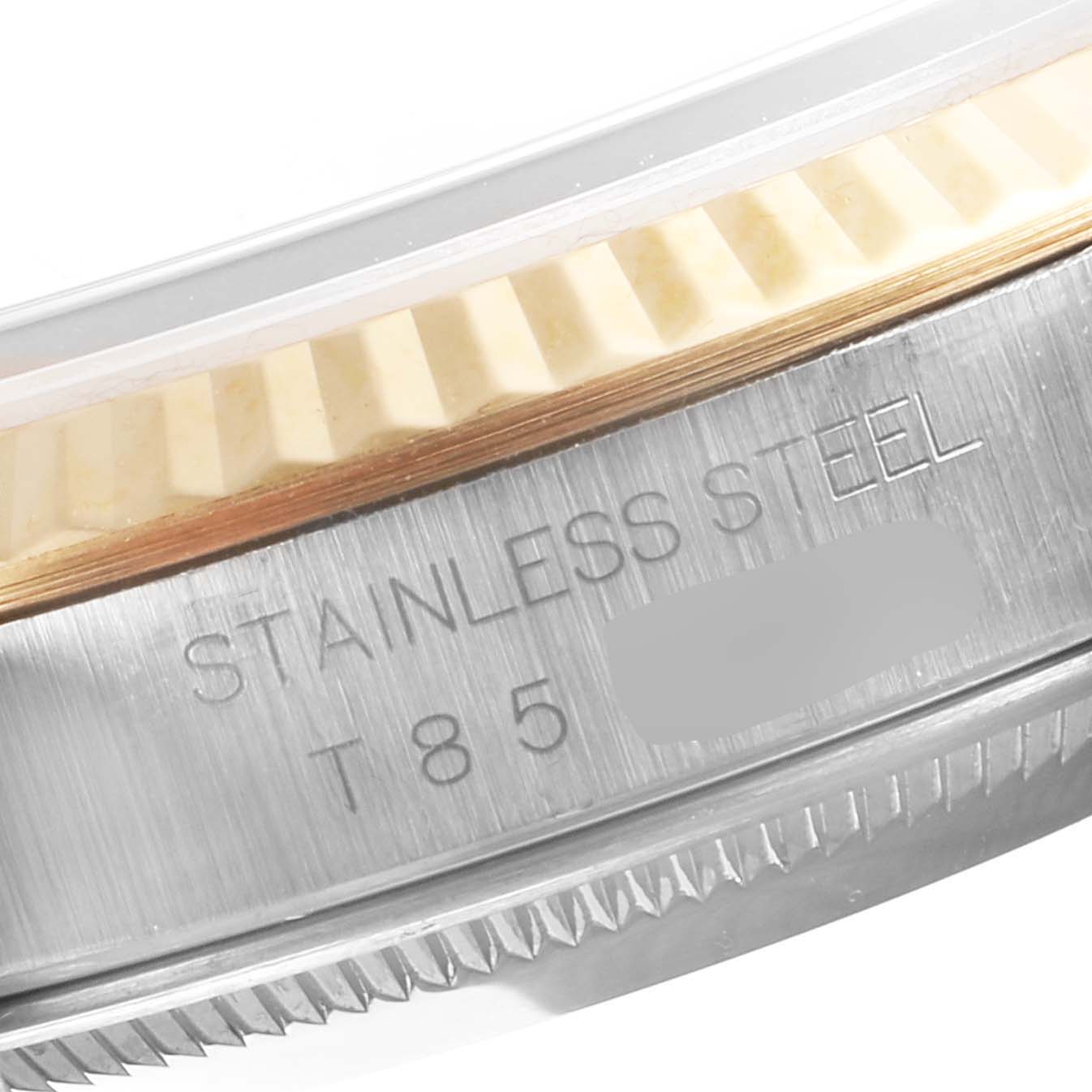 This close-up image shows the side of a Rolex Datejust 16233 Men's Steel and Gold (two tone) Black Dial 16233 Men's Steel and Gold (two tone) Black Dial watch case, highlighting the stainless steel engraving and part of the bezel.