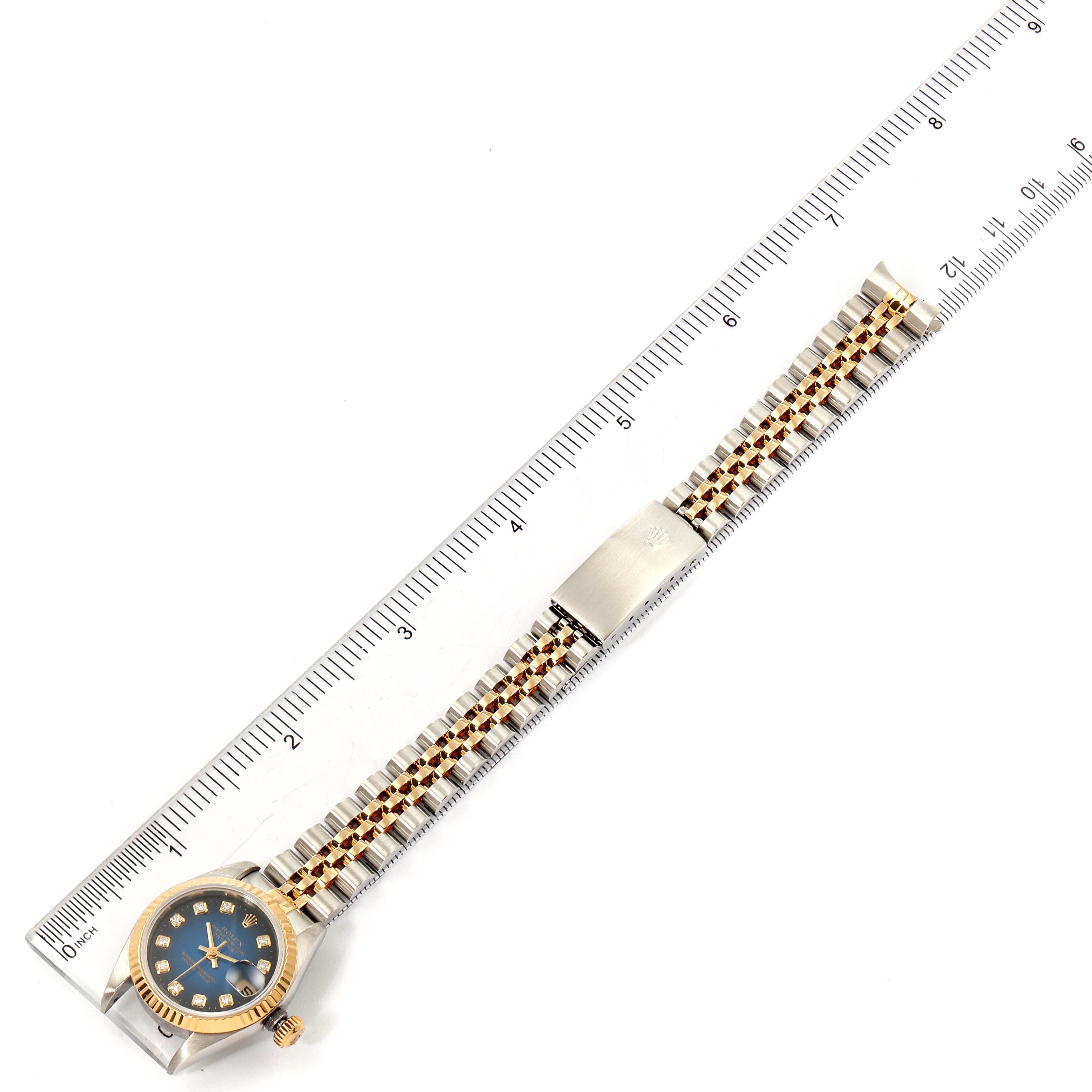 The Rolex Datejust 79173 Women's Steel and Gold (two tone) Blue Dial 79173 Women's Steel and Gold (two tone) Blue Dial is shown from a top-down view, displaying the full watch band and face alongside a measuring ruler.