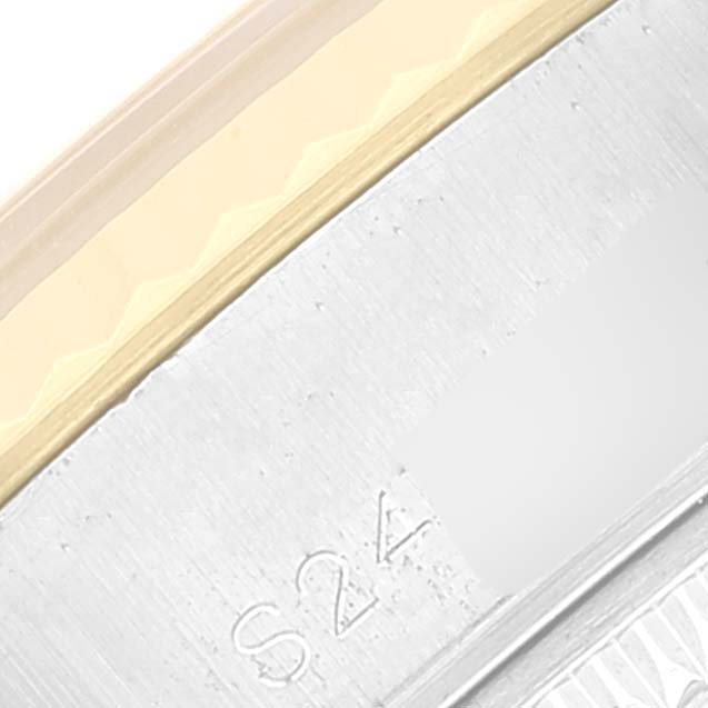 This close-up image shows part of the bezel and case of a Rolex Datejust 69173 Women's Steel and Gold (two tone) White Dial 69173 Women's Steel and Gold (two tone) White Dial watch.