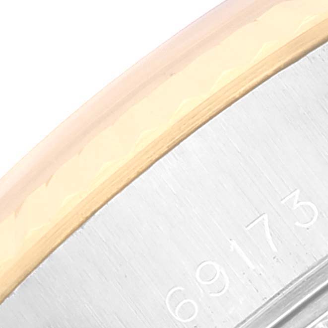 This close-up image of the Rolex Datejust 69173 Women's Steel and Gold (two tone) White Dial 69173 Women's Steel and Gold (two tone) White Dial model shows part of the watch case and the serial number.