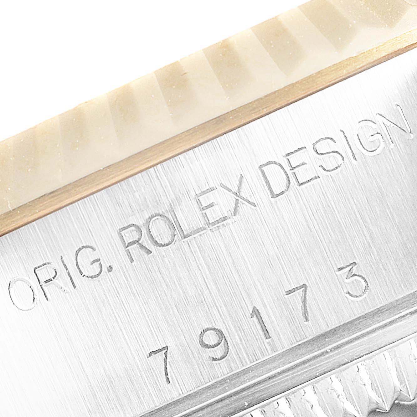 The image shows a close-up of the bezel and serial number engraving on a Rolex Datejust 79173 Women
s Steel and Gold (two tone) Champagne Dial 79173 Women
s Steel and Gold (two tone) Champagne Dial watch.