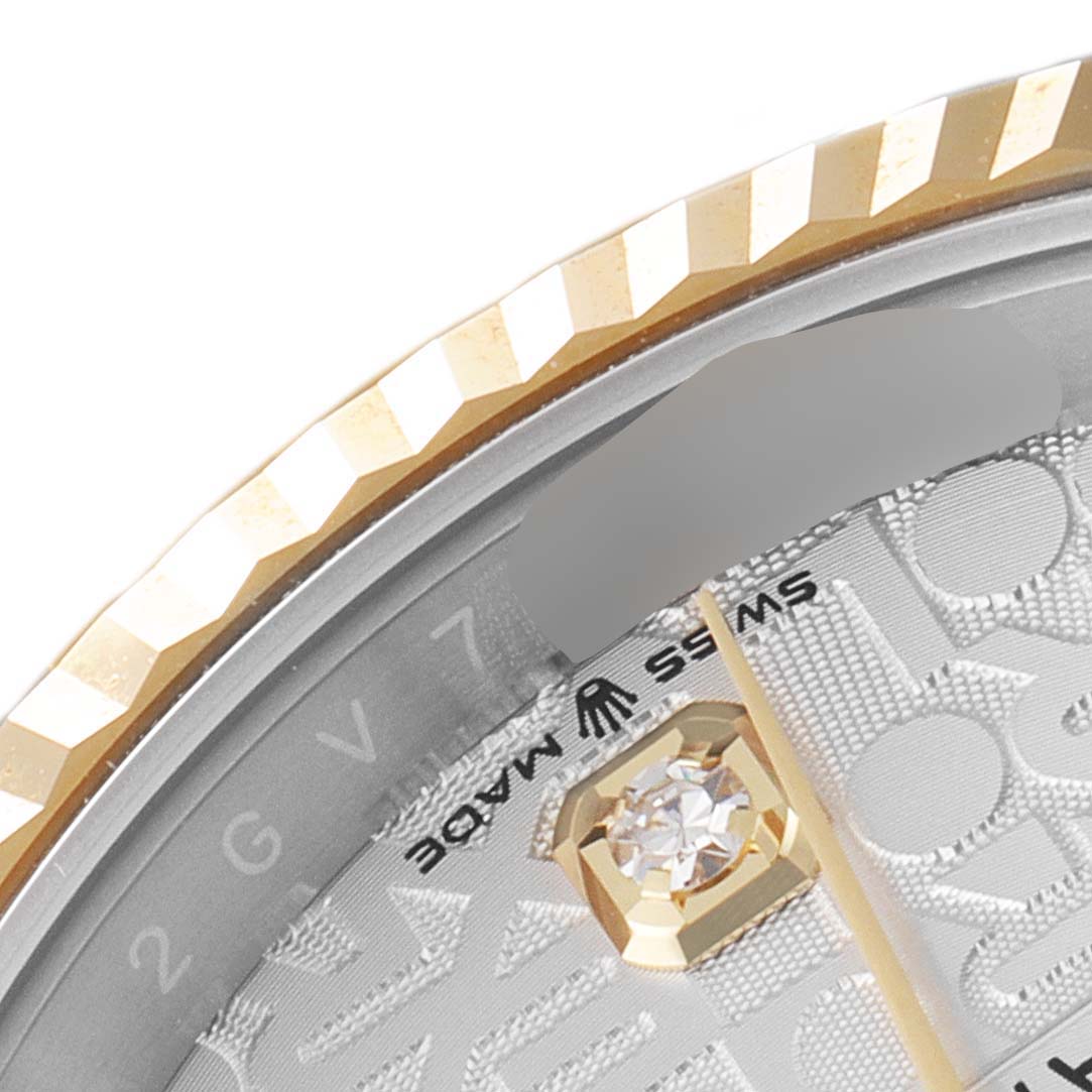 This image shows a close-up of the bezel, dial, and part of the diamond hour marker of a Rolex Datejust 126233 Men's Steel and Gold (two tone) Silver Dial 126233 Men's Steel and Gold (two tone) Silver Dial watch.