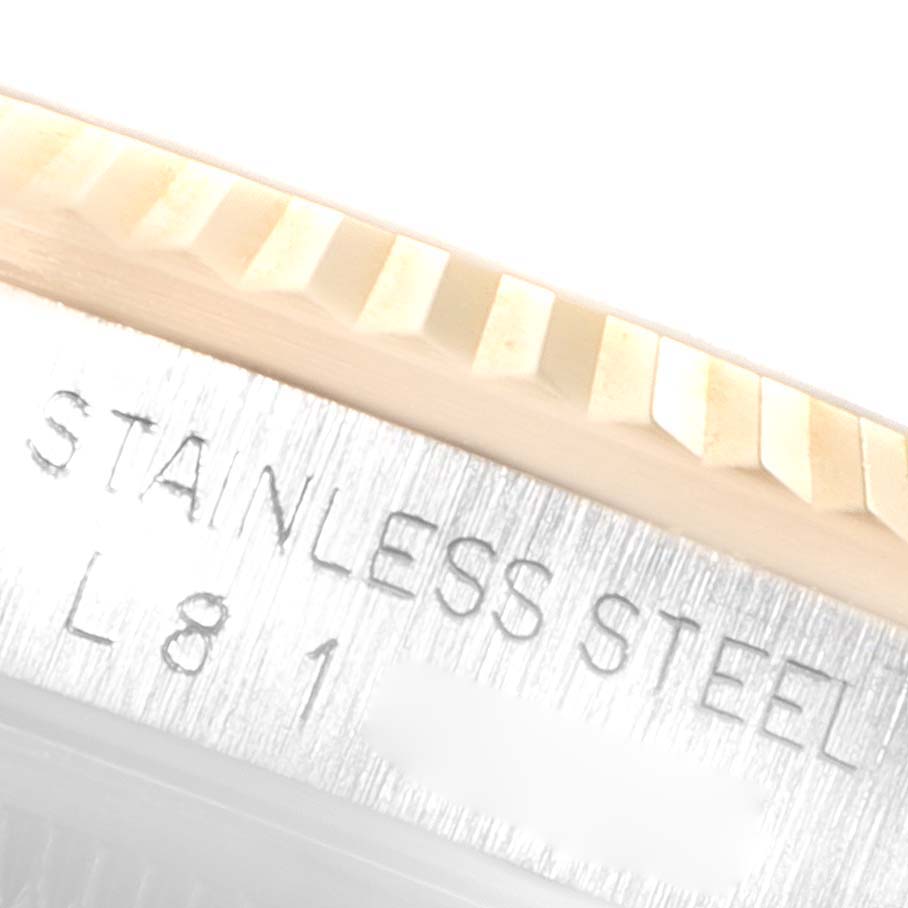 This close-up image shows the fluted bezel and part of the case engraving of a Rolex Datejust 16233 Men's Steel and Gold (two tone) Champagne Dial 16233 Men's Steel and Gold (two tone) Champagne Dial watch.