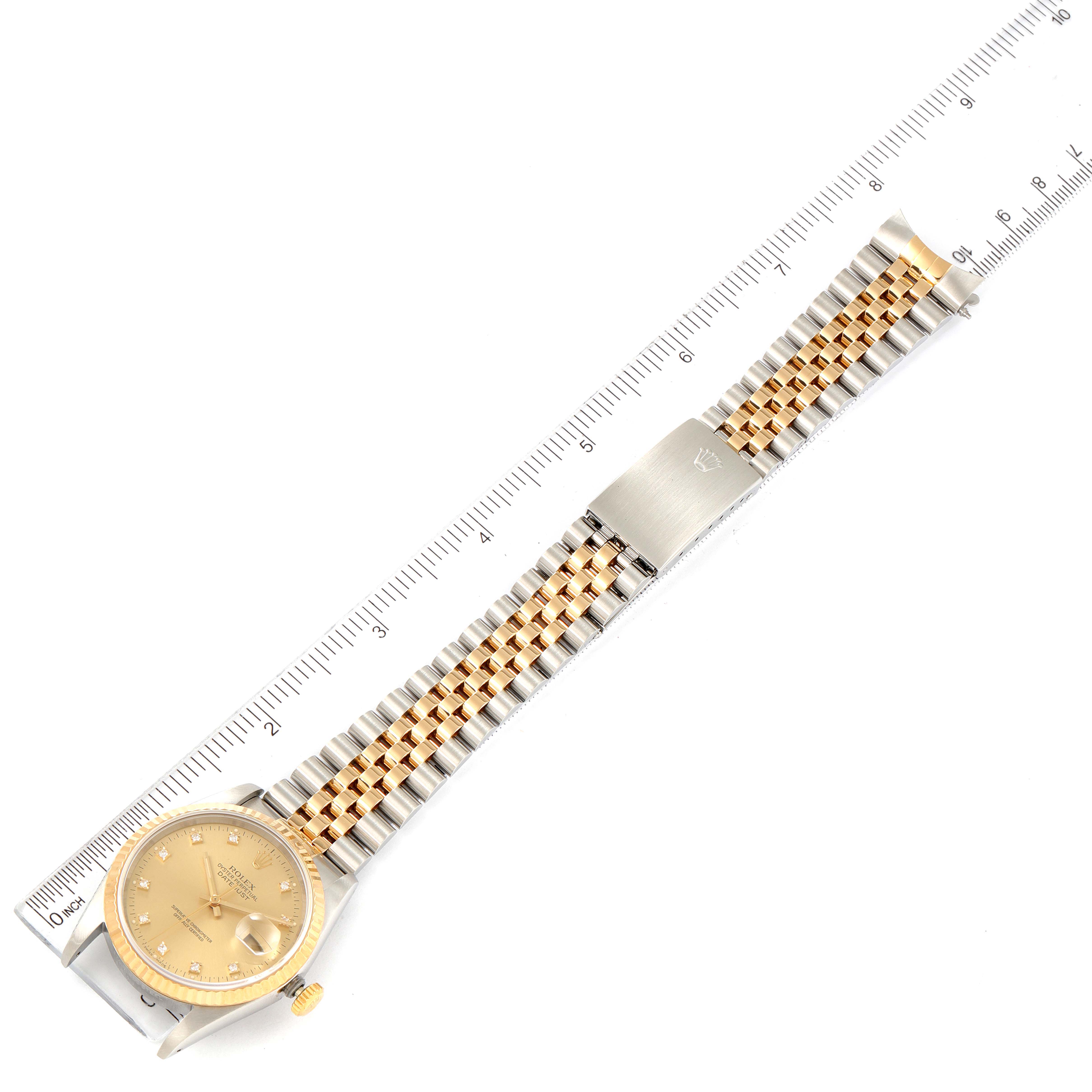 This image shows a Rolex Datejust 16233 Men's Steel and Gold (two tone) Champagne Dial 16233 Men's Steel and Gold (two tone) Champagne Dial watch laid flat, showcasing its dial and two-tone bracelet next to a ruler for measurement.