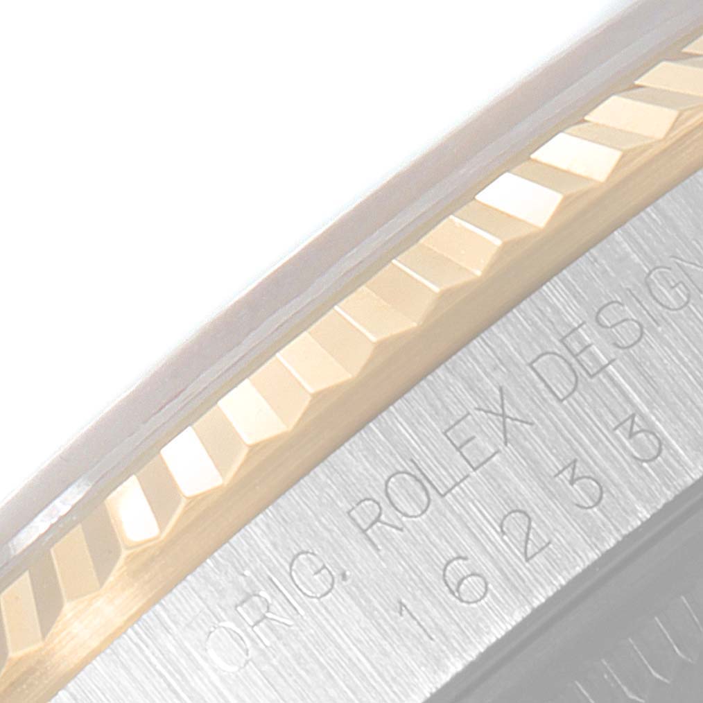 This close-up shows the fluted bezel and engraved text on the side of the Rolex Datejust 16233 Men
s Steel and Gold (two tone) Champagne Dial 16233 Men
s Steel and Gold (two tone) Champagne Dial watch.