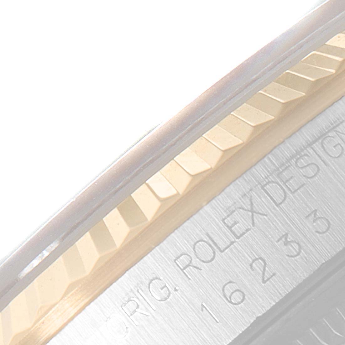 This image shows a close-up of the fluted bezel and part of the case of a Rolex Datejust 16233 Men's Steel and Gold (two tone) Champagne Dial 16233 Men's Steel and Gold (two tone) Champagne Dial watch.