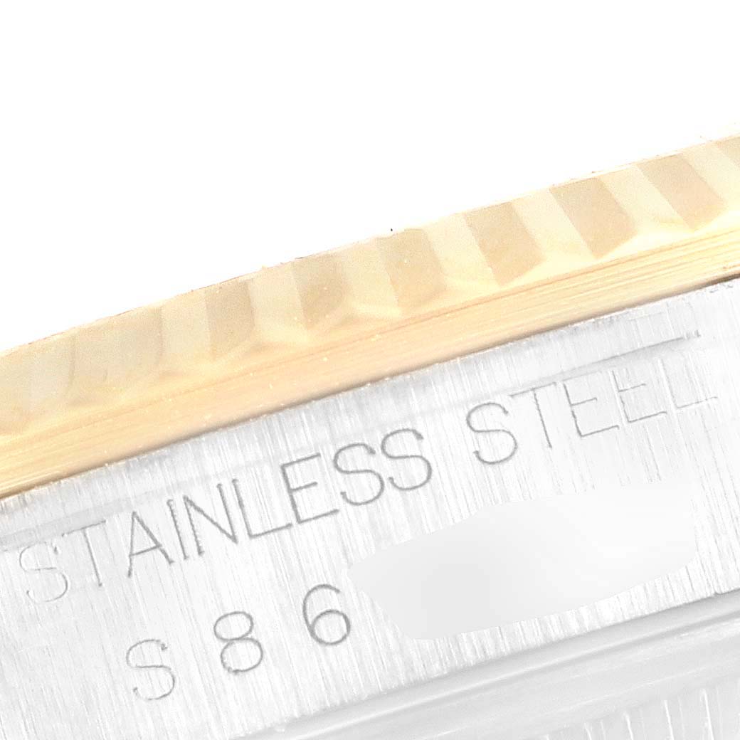 This is a close-up of the Rolex Datejust 16233 Men's Steel and Gold (two tone) White Dial 16233 Men's Steel and Gold (two tone) White Dial watch, showing the stainless steel case and the fluted bezel.