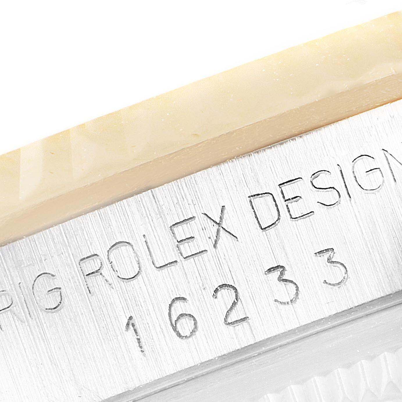 Close-up view of the side of a Rolex Datejust 16233 Men's Steel and Gold (two tone) White Dial 16233 Men's Steel and Gold (two tone) White Dial watch showing its model number 16233 engraved on the bezel.