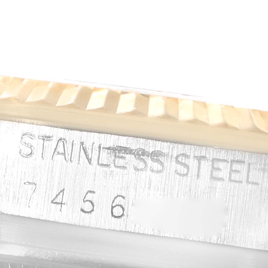 The image shows a close-up of the side of the Rolex Datejust 16013 Men's Steel and Gold (two tone) White Dial 16013 Men's Steel and Gold (two tone) White Dial, featuring the fluted bezel and part of the serial number engraving.