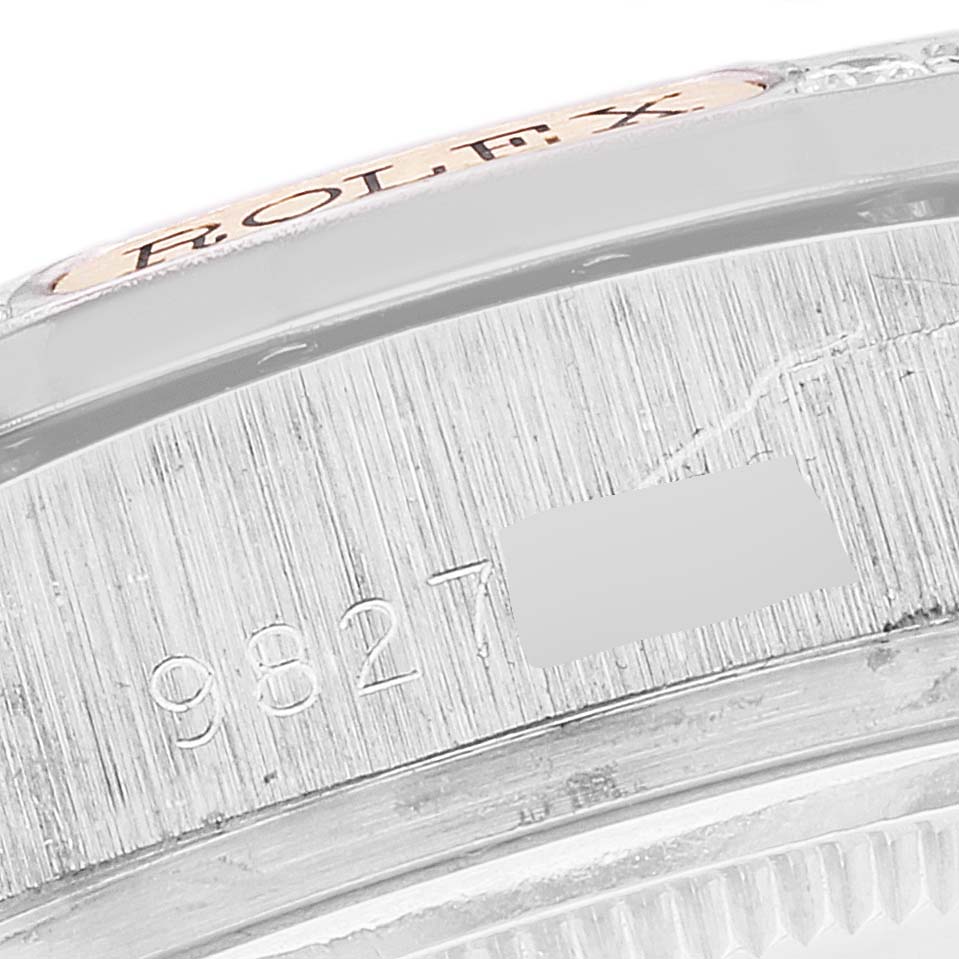 The image shows a close-up of the edge of a Rolex President 18139 Men's White Gold Brown Dial 18139 Men's White Gold Brown Dial model watch, focusing on the engraved serial number and part of the bezel.