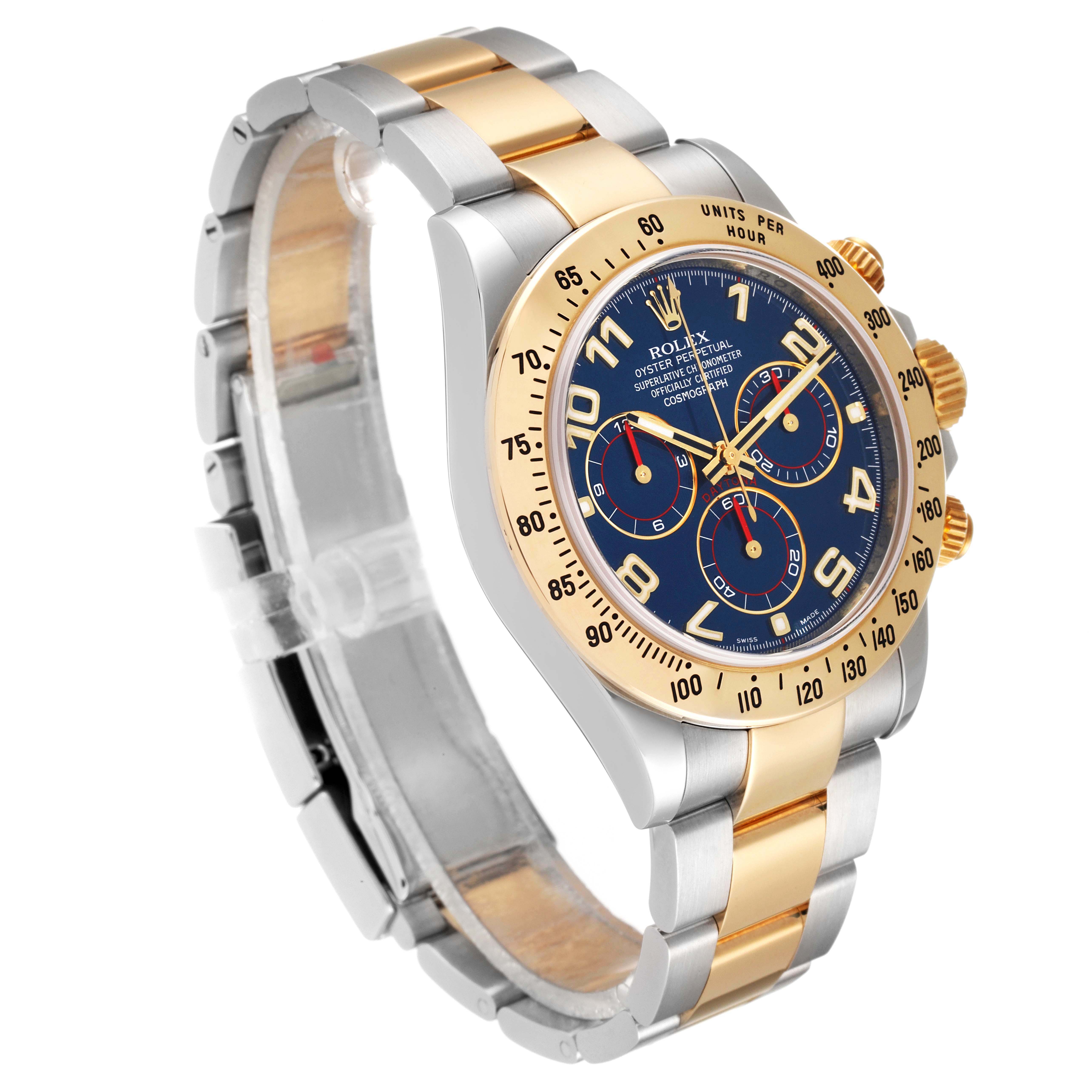 The Rolex Daytona 116523 Men
s Steel and Gold (two tone) Blue Dial 116523 Men
s Steel and Gold (two tone) Blue Dial watch is shown at a three-quarter angle, highlighting its blue dial, gold bezel, and two-tone bracelet.