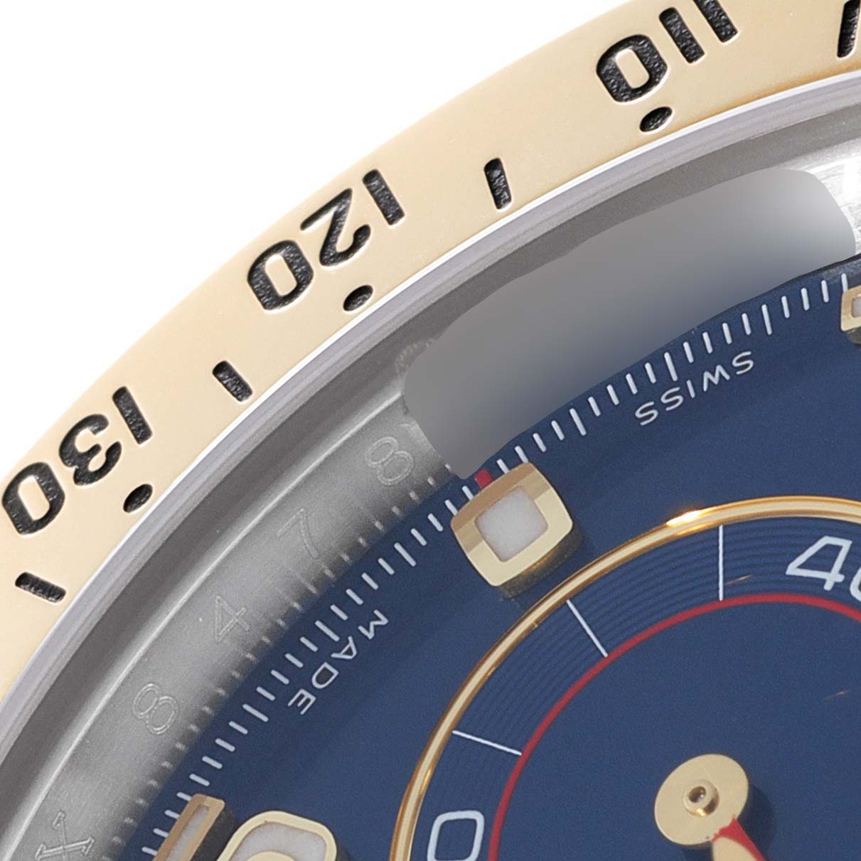 This image shows a close-up of the dial and bezel of a Rolex Daytona 116523 Men
s Steel and Gold (two tone) Blue Dial 116523 Men
s Steel and Gold (two tone) Blue Dial watch at an oblique angle.