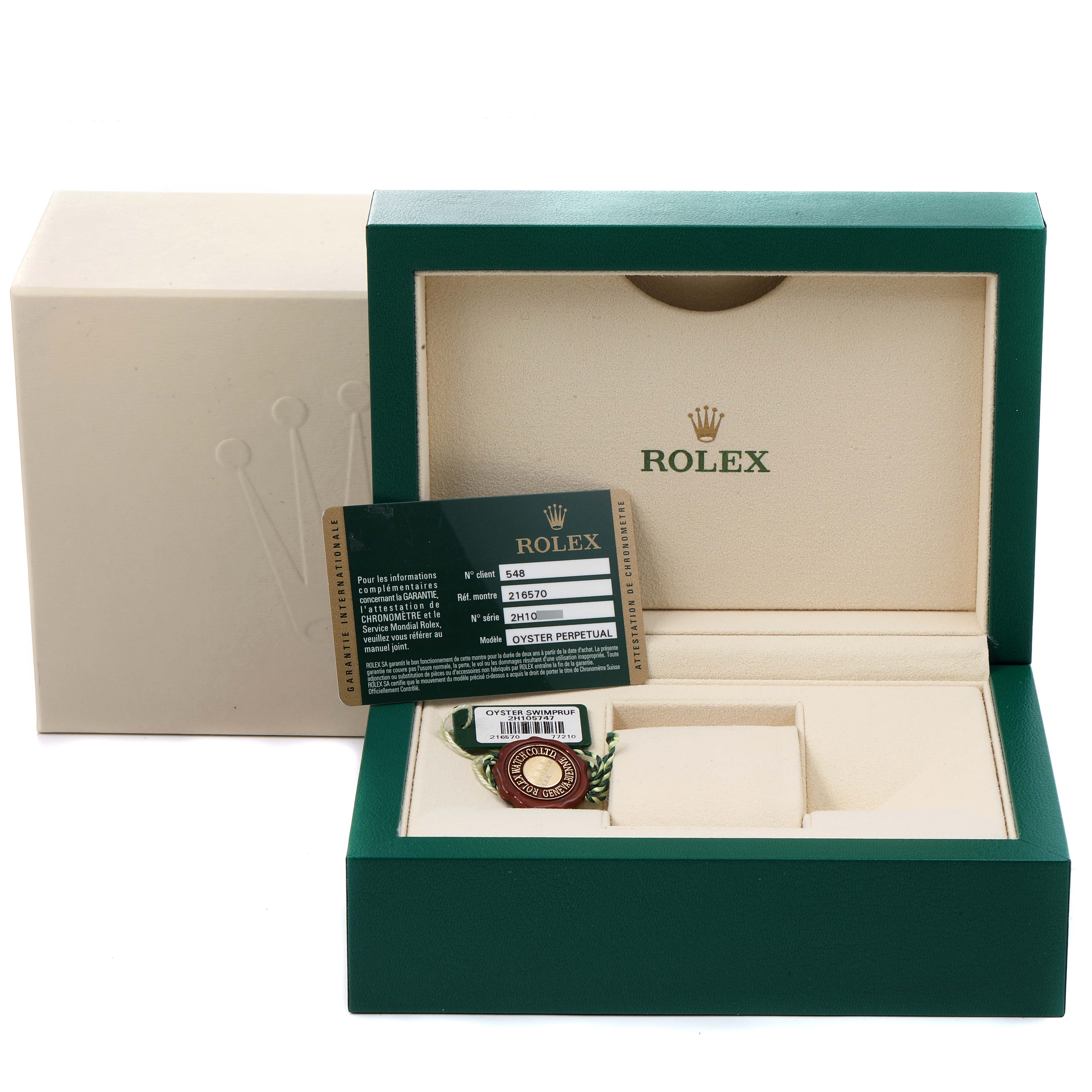 The image shows the packaging, warranty card, and tag for the Rolex Explorer 216570 Men
s Stainless Steel White Dial 216570 Men
s Stainless Steel White Dial watch, with the watch box open.