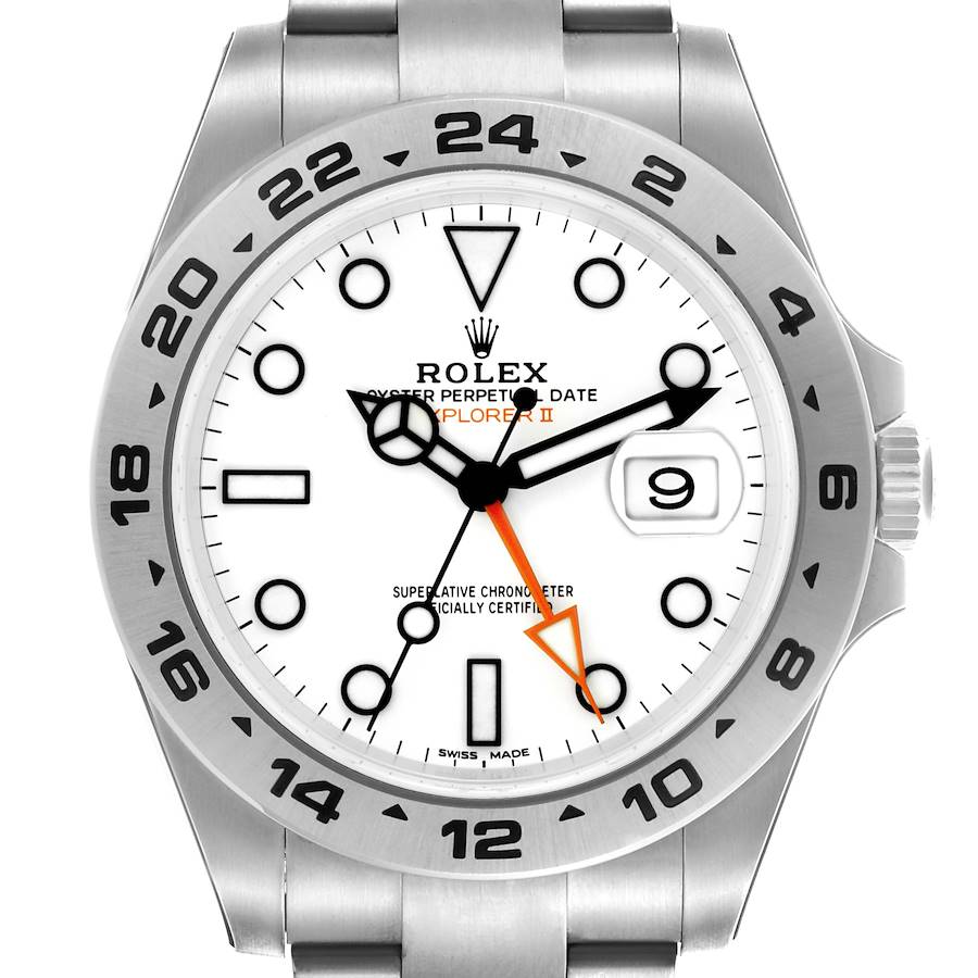 The Rolex Explorer II watch is shown from a front angle, highlighting the dial, bezel, hands, and steel bracelet.