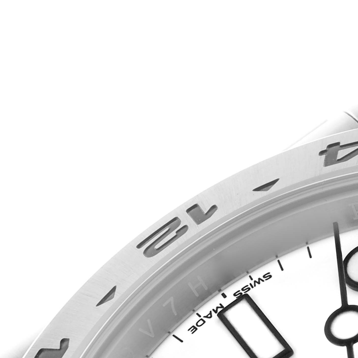 The image shows a close-up of the bezel and partial dial of a Rolex Explorer 216570 Men's Stainless Steel White Dial 216570 Men's Stainless Steel White Dial, highlighting the engraved numbers and markers.