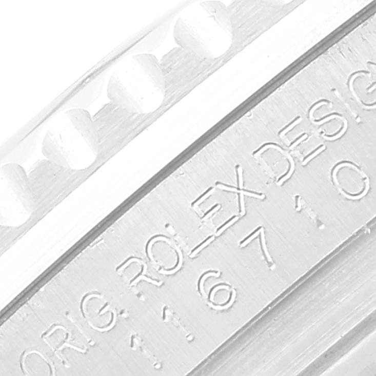 This close-up image shows the engraved text and part of the notched bezel of a Rolex GMT-Master 116710 Men's Stainless Steel Black Dial 116710 Men's Stainless Steel Black Dial watch.
