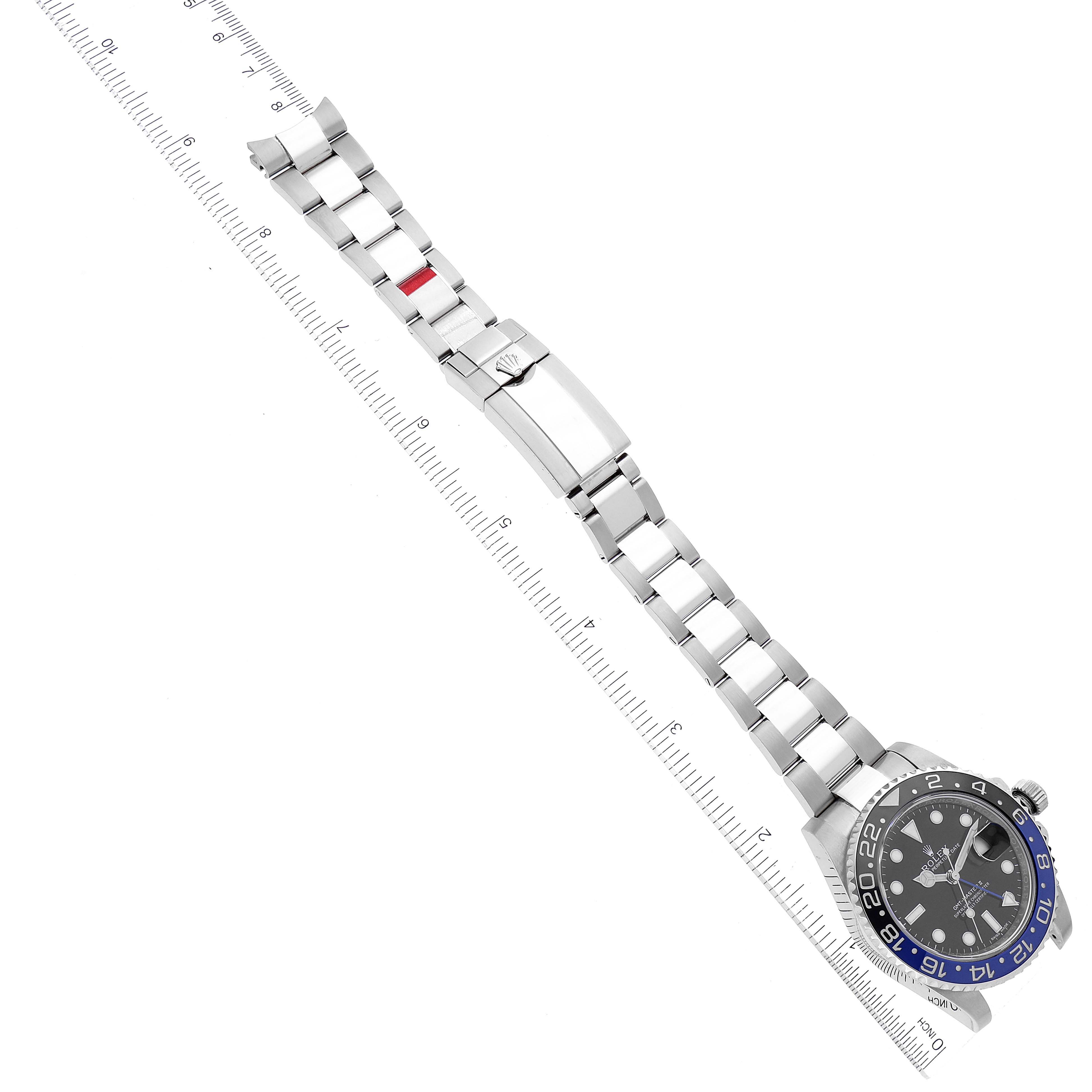 The image shows a Rolex GMT-Master 116710 Men's Stainless Steel Black Dial 116710 Men's Stainless Steel Black Dial watch lying flat, displaying the face, bezel, bracelet, and clasp alongside a ruler.