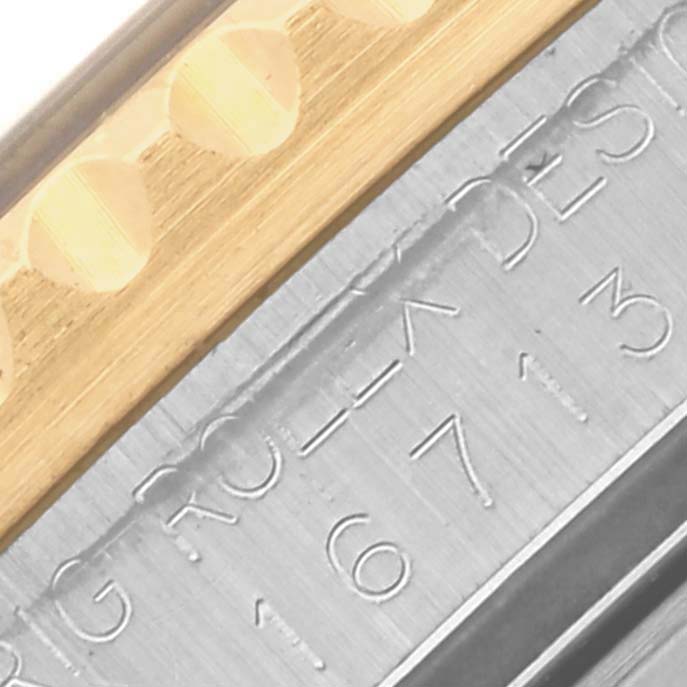 The image shows a close-up of the side of a Rolex GMT-Master 16713 Men's Steel and Gold (two tone) Black Dial 16713 Men's Steel and Gold (two tone) Black Dial watch, focusing on the metal bracelet with visible screws.