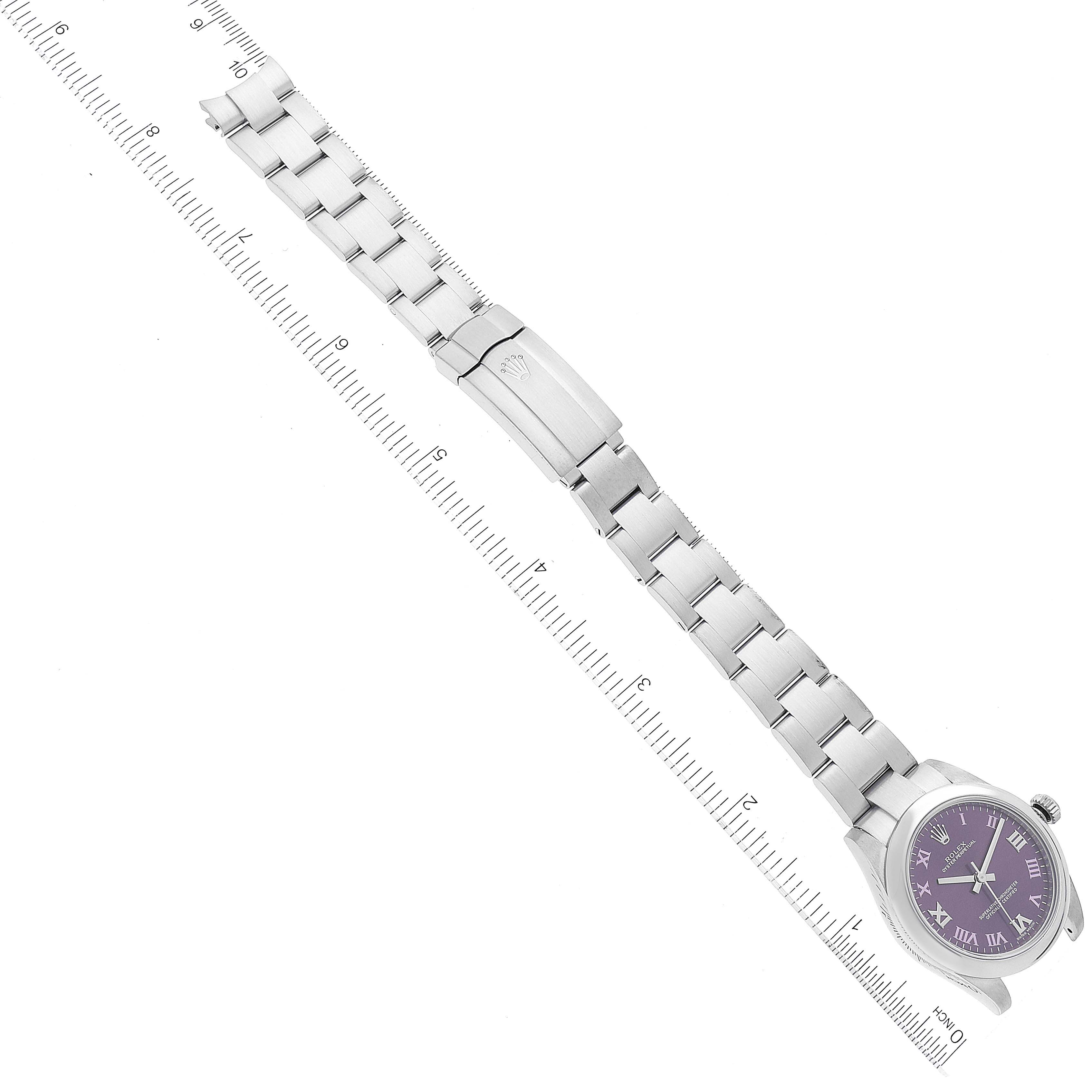 The image shows a Rolex Mid-Size 177200 Women's Stainless Steel Burgundy Dial 177200 Women's Stainless Steel Burgundy Dial watch with a purple dial, photographed from an overhead angle with its metal bracelet and clasp visible.