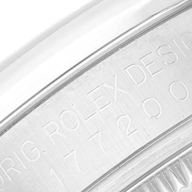 The image shows a close-up of the casing with engraved text and numbers of a Rolex Mid-Size 177200 Women's Stainless Steel Burgundy Dial 177200 Women's Stainless Steel Burgundy Dial model watch.